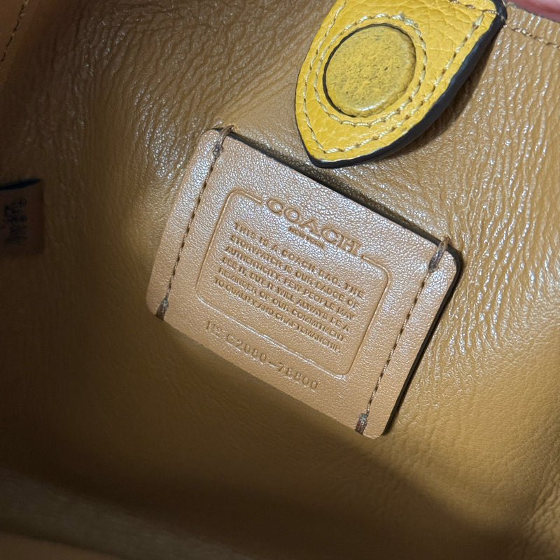 Coach Mini Yellow Leather Bag with pebbled leather texture, dual top handles, and a spacious open interior.