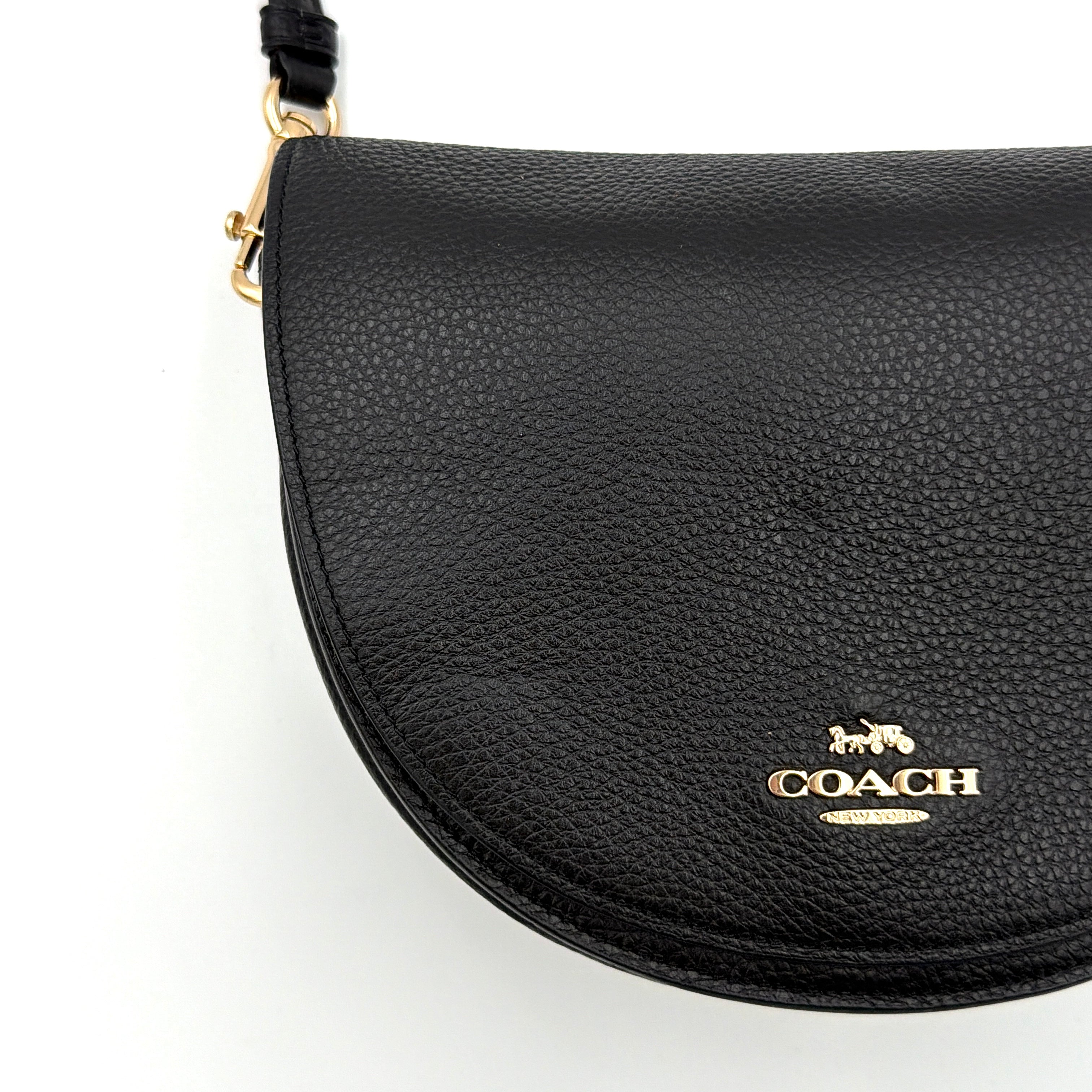 Coach Ellen Crossbody Bag in black pebbled leather with a half-moon silhouette, gold-tone hardware, and adjustable strap.