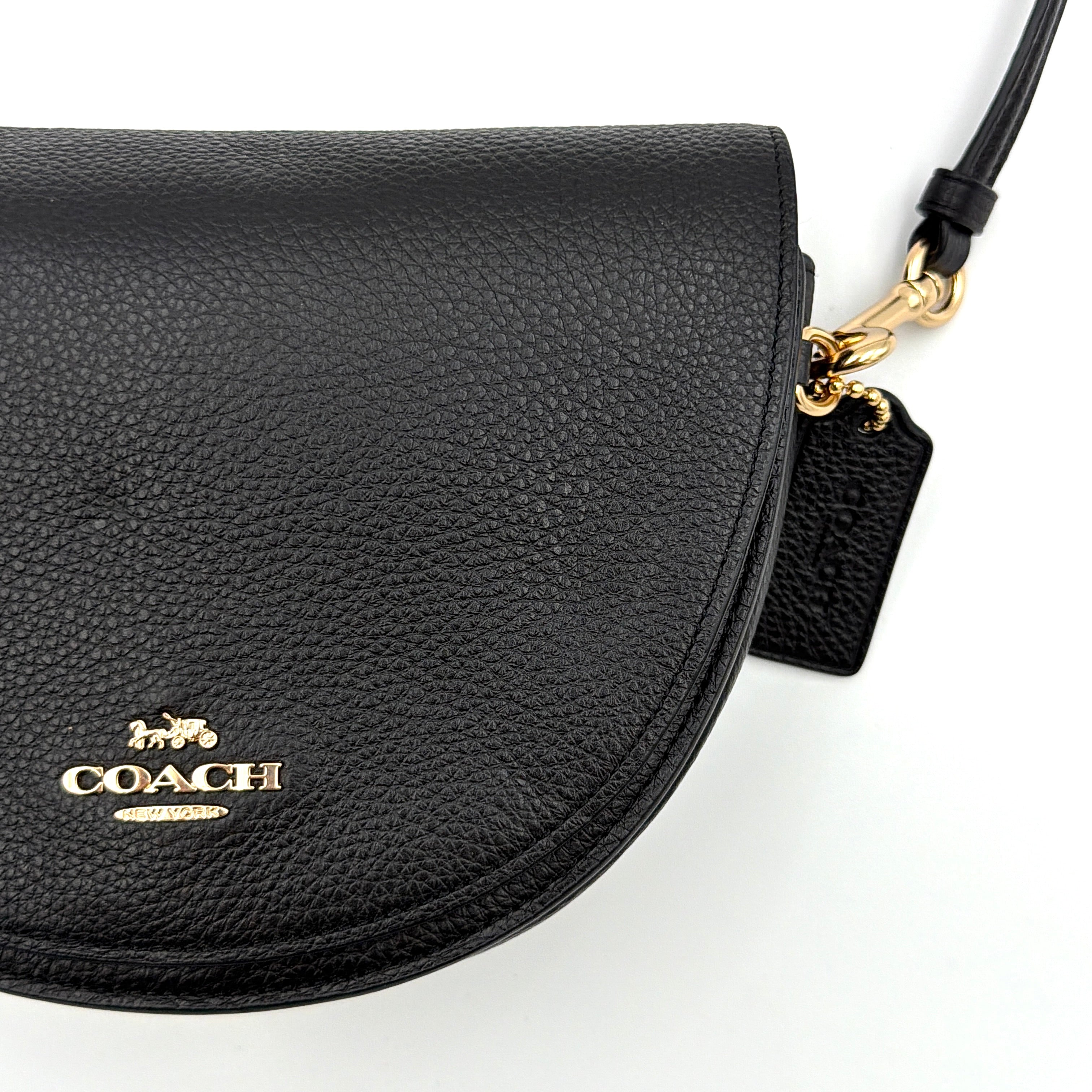 Coach Ellen Crossbody Bag in black pebbled leather with a half-moon silhouette, gold-tone hardware, and adjustable strap.