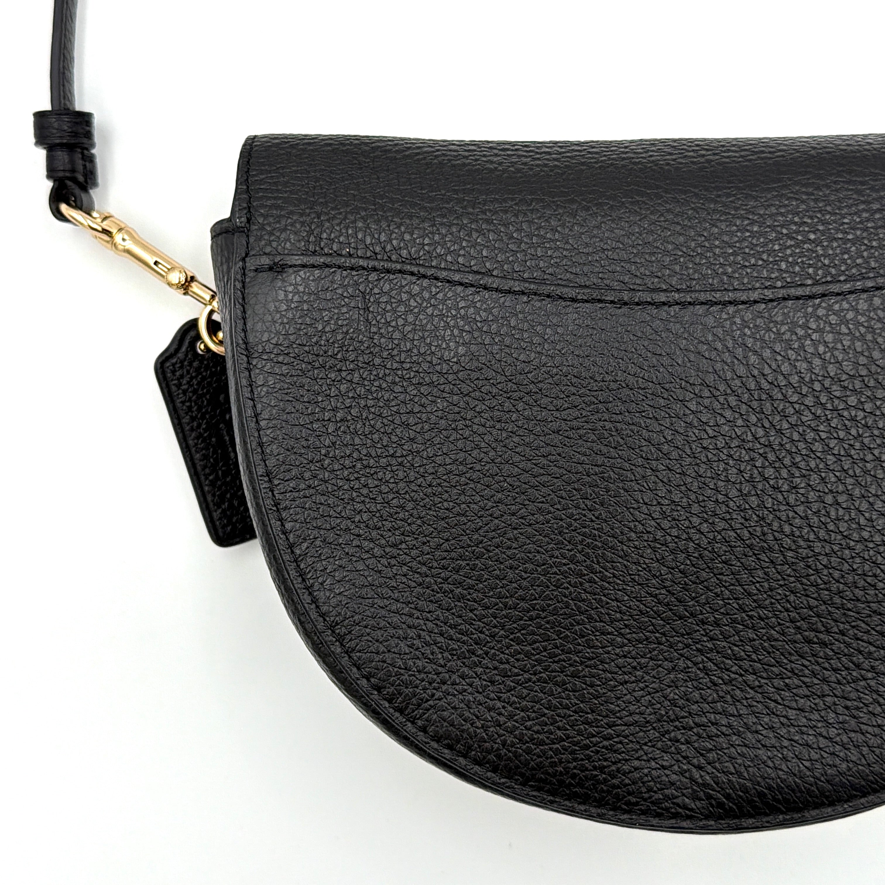 Coach Ellen Crossbody Bag in black pebbled leather with a half-moon silhouette, gold-tone hardware, and adjustable strap.