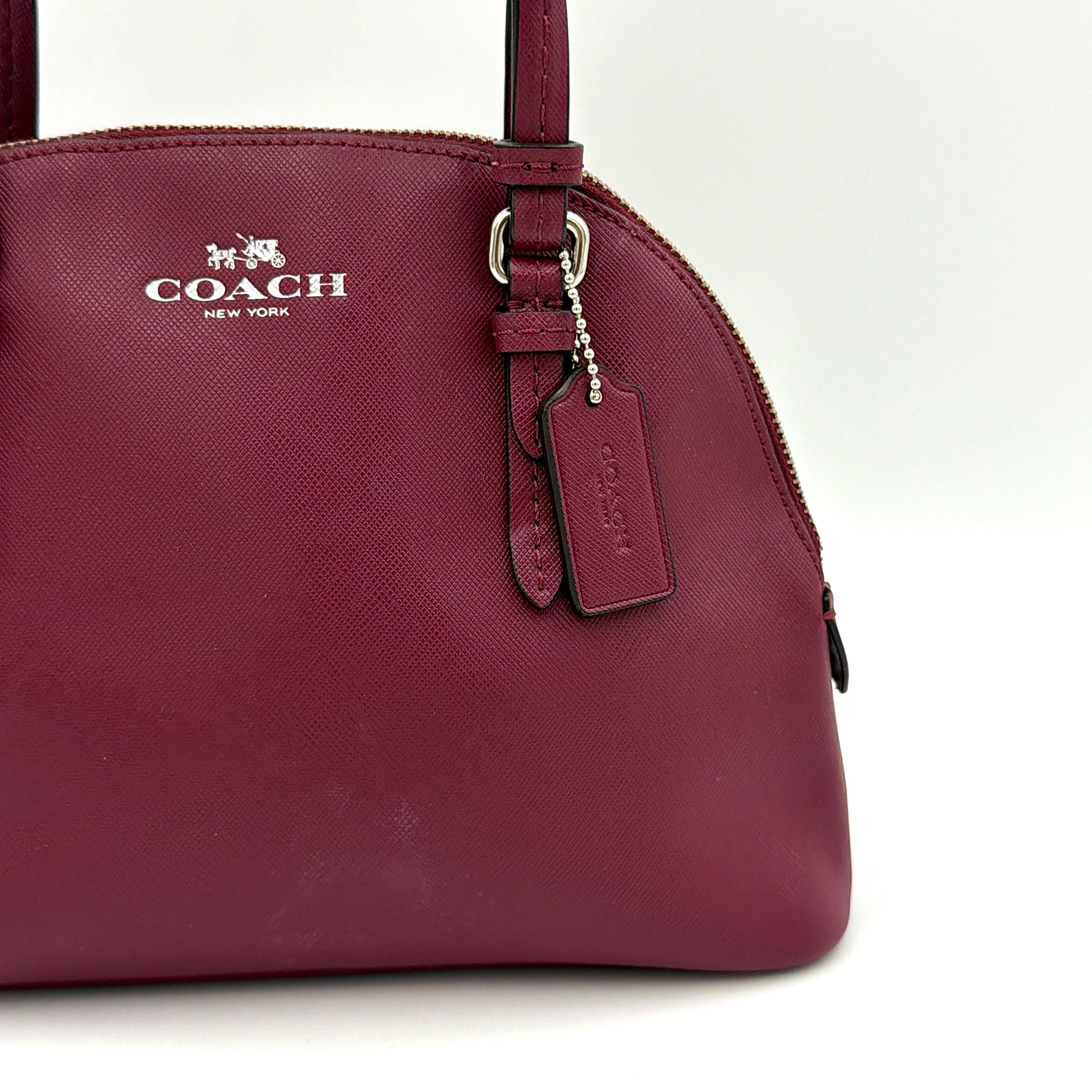 Coach Peyton satchel in burgundy crossgrain leather with silver hardware, shown with its detachable shoulder strap.