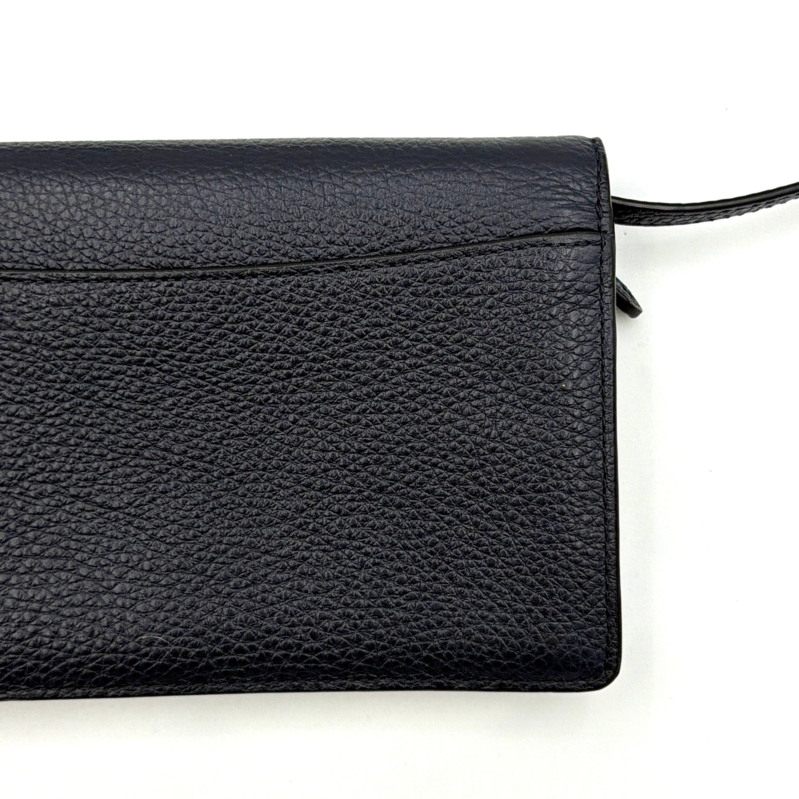 Coach Anna Foldover Clutch Crossbody Bag in navy pebbled leather with slim strap and gold logo detailing.