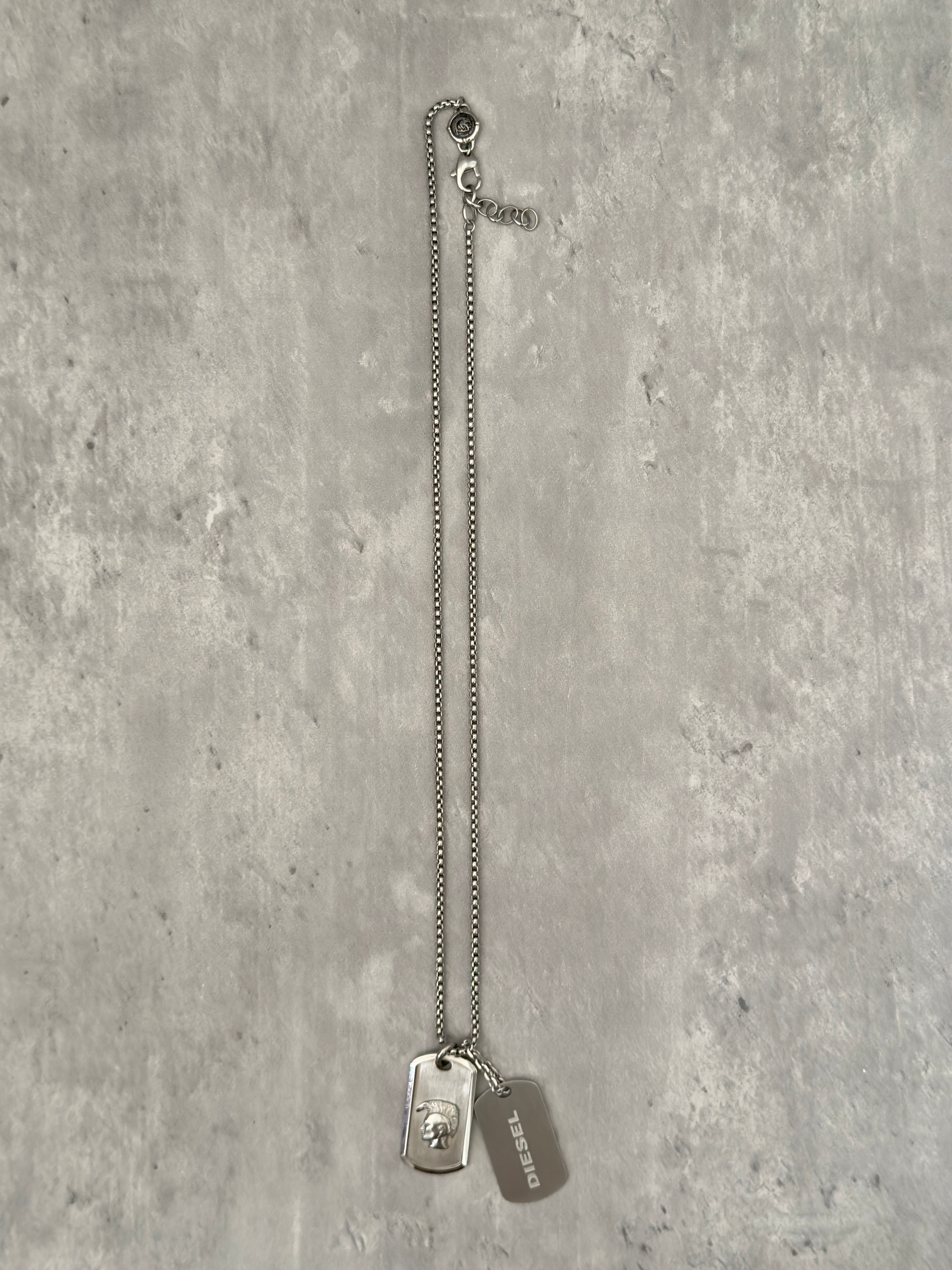 Diesel Double Plate Dog Tag Pendant Necklace in silver-tone stainless steel, featuring a Mohawk head engraving and Diesel logo.