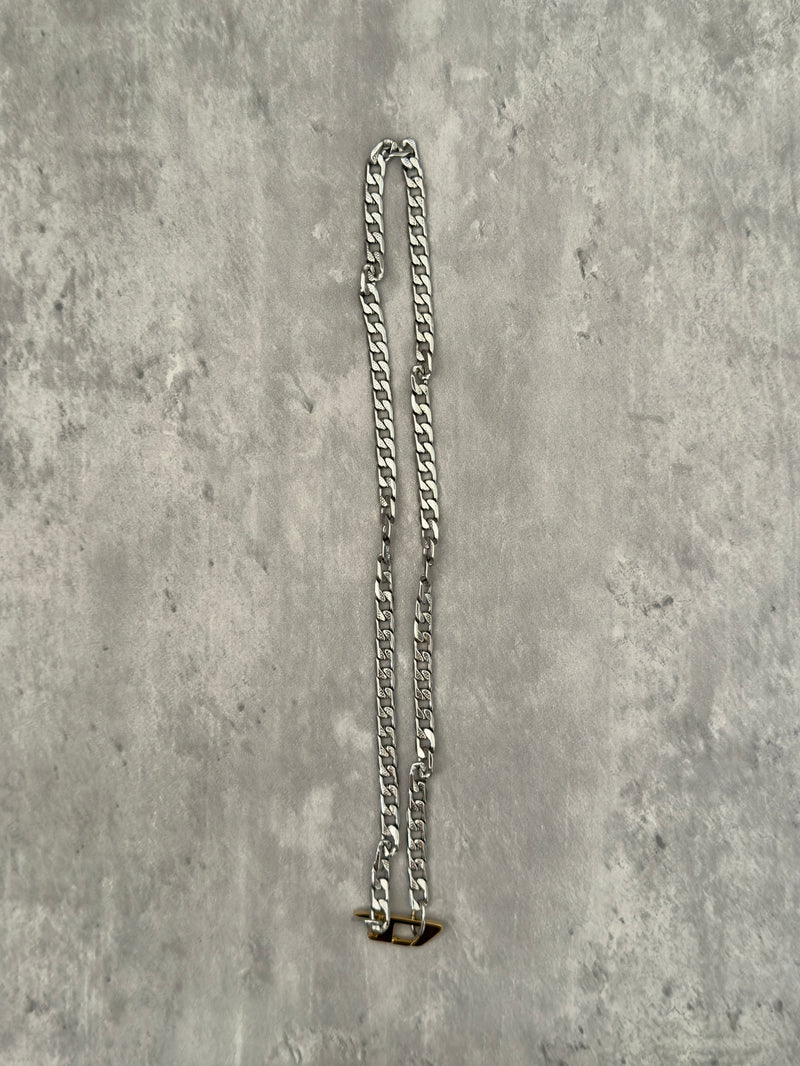 Diesel Signature Gold D-Logo Stainless Steel Necklace, featuring a silver-tone chunky chain with a gold-tone Diesel "D" logo pendant.