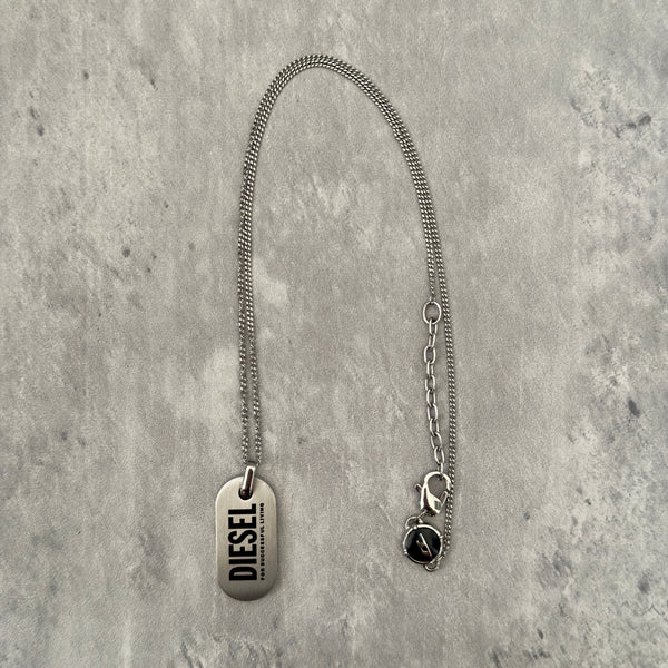 Diesel Signature 'For Successful Living' Dog Tag Necklace in stainless steel, featuring a brushed metal pendant and fine box chain.