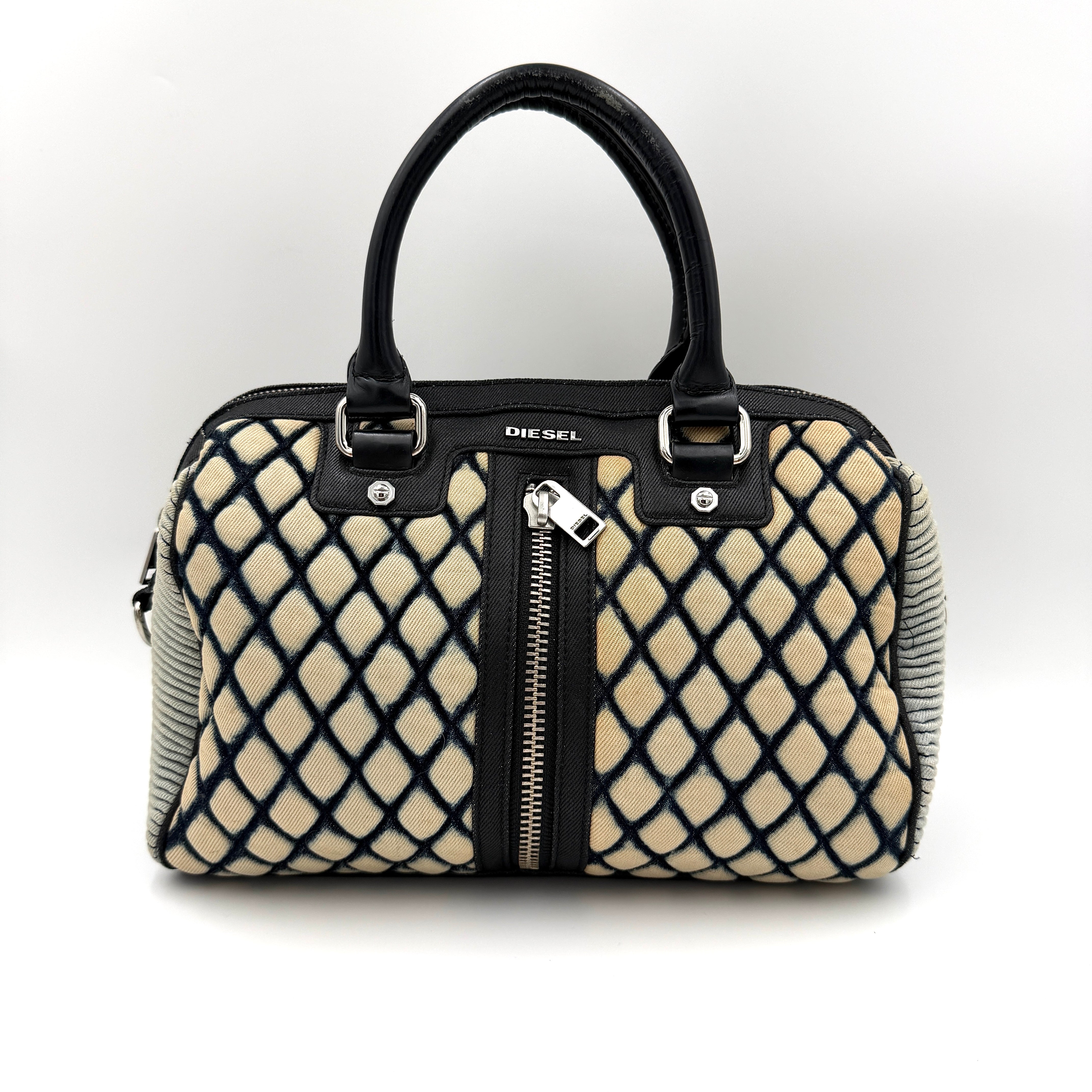 Diesel 2Way Boston Handbag in cream canvas with black velvet-effect lattice, dual leather handles, and detachable strap displayed in front.