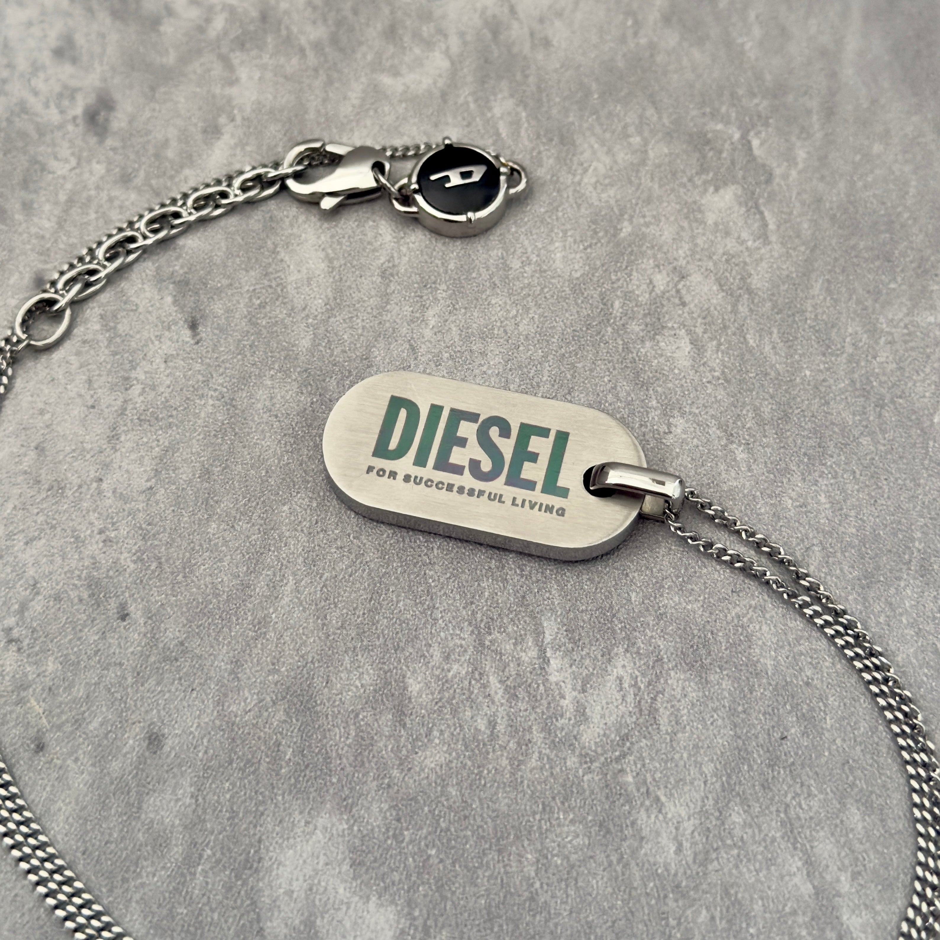 Diesel Signature 'For Successful Living' Dog Tag Necklace in stainless steel, featuring a brushed metal pendant and fine box chain.