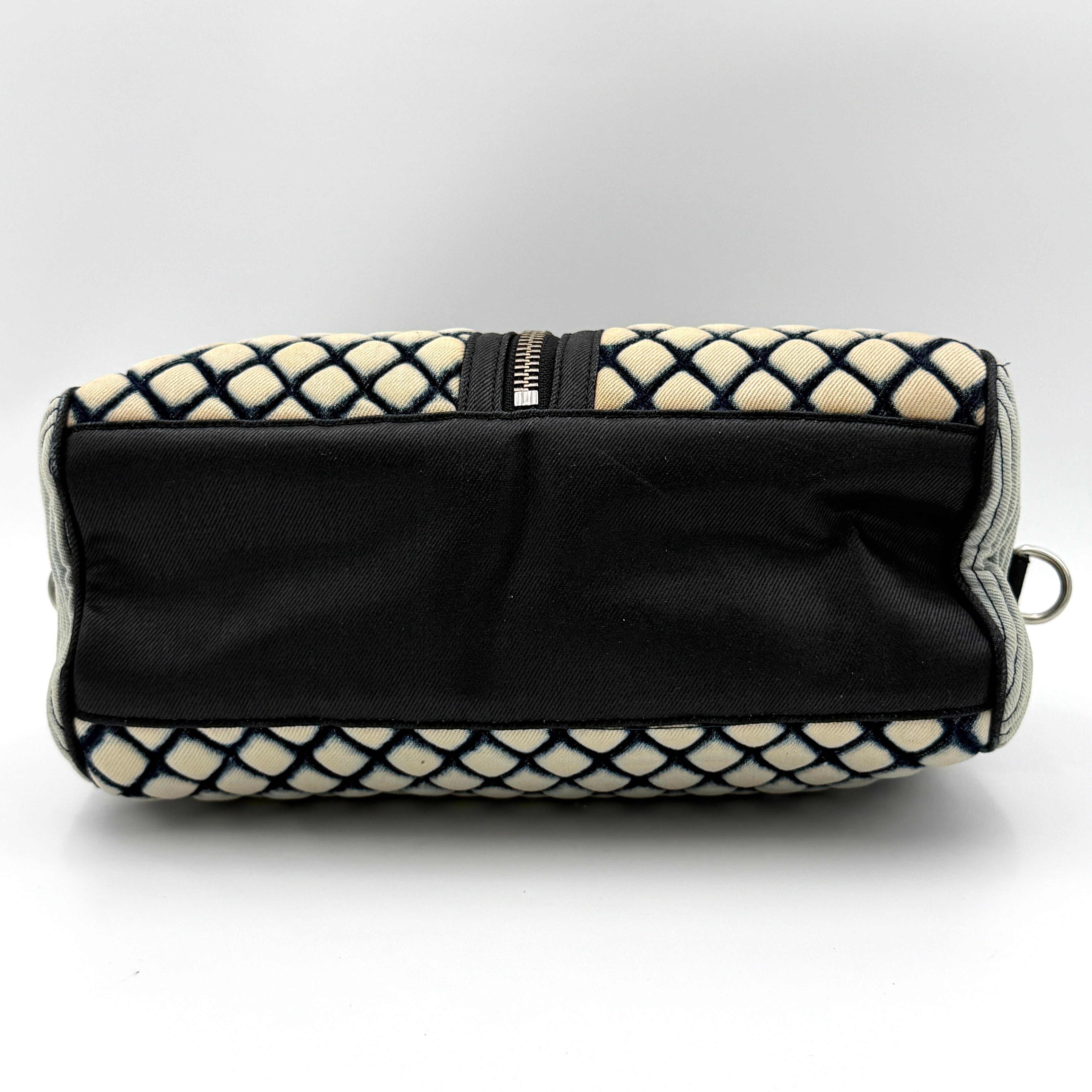 Diesel 2Way Boston Handbag in cream canvas with black velvet-effect lattice, dual leather handles, and detachable strap displayed in front.
