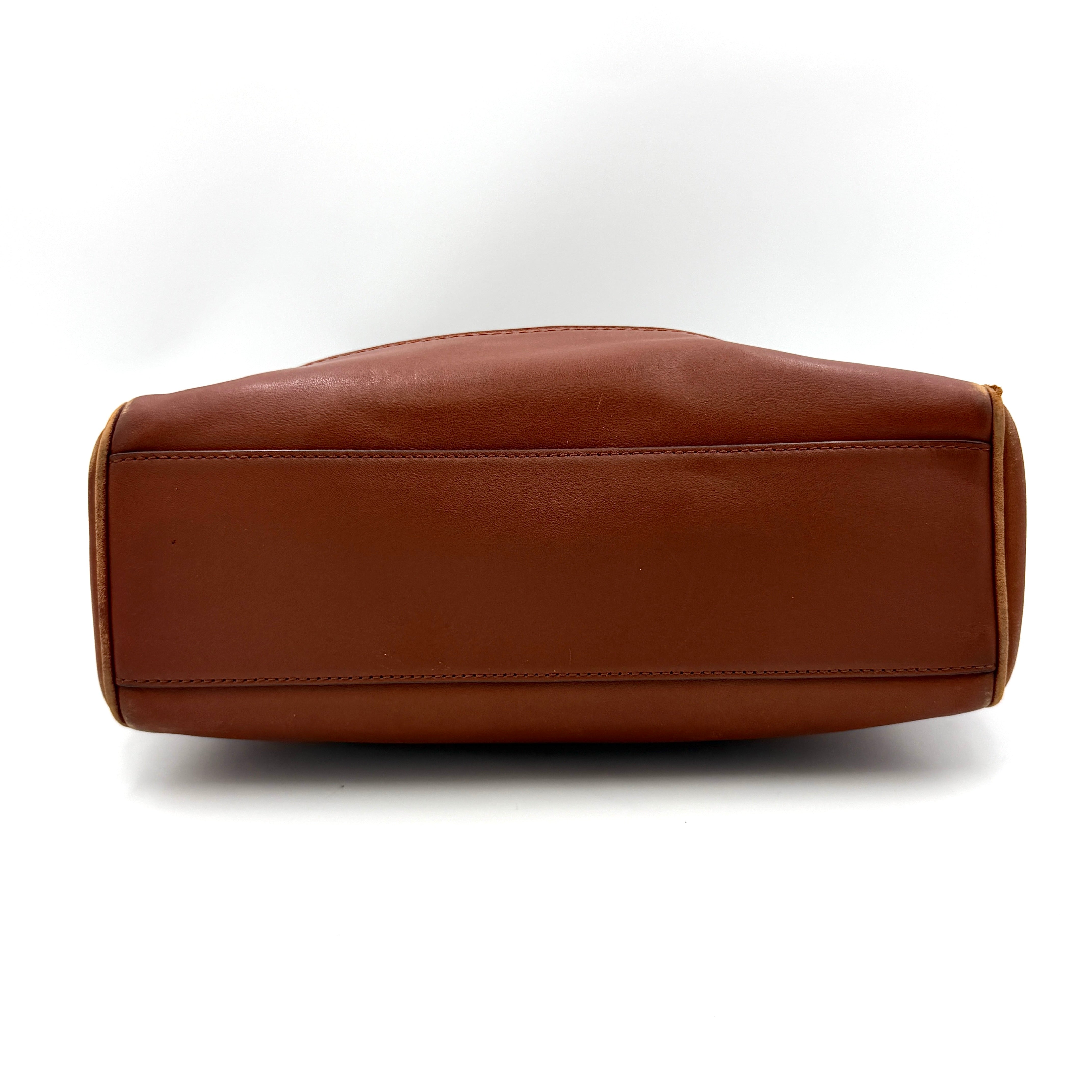 Coach Legacy Candace Carryall in smooth brown leather with gold hardware, rolled handles, and signature tassel accents.