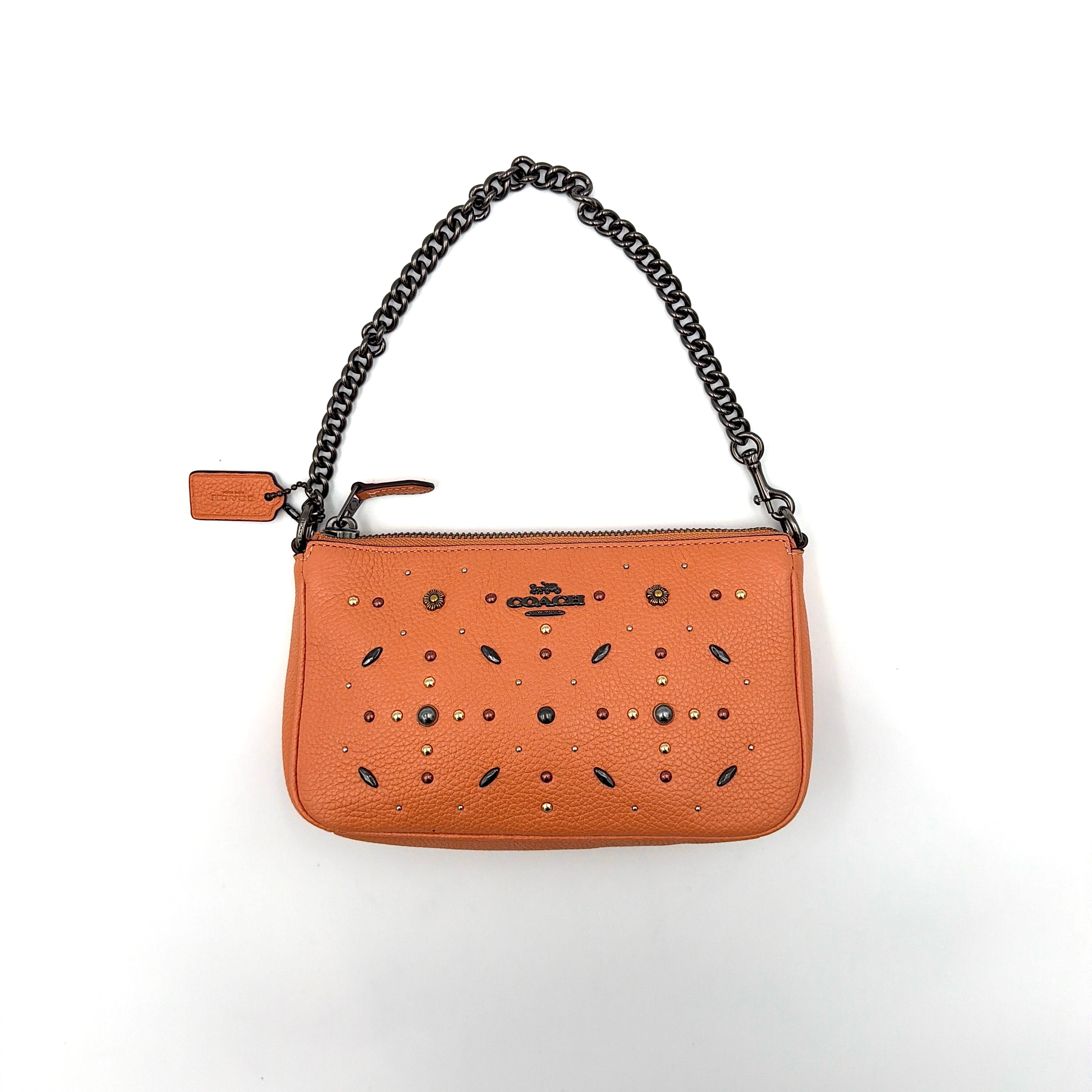 Coach Nolita 19 Prairie Rivets Shoulder Bag in bold orange pebbled leather with mixed metal rivet embellishments and chunky chain strap.
