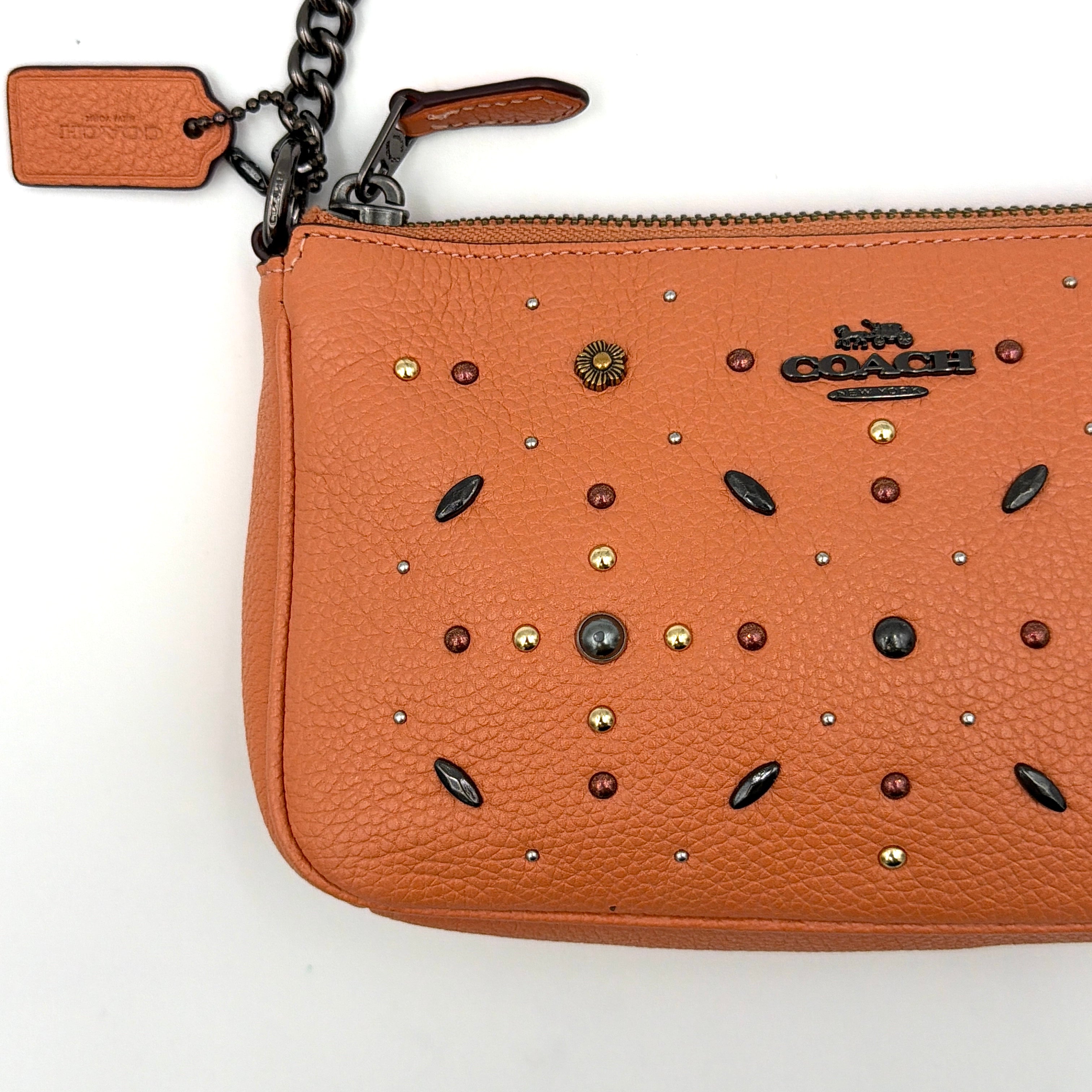 Coach Nolita 19 Prairie Rivets Shoulder Bag in bold orange pebbled leather with mixed metal rivet embellishments and chunky chain strap.