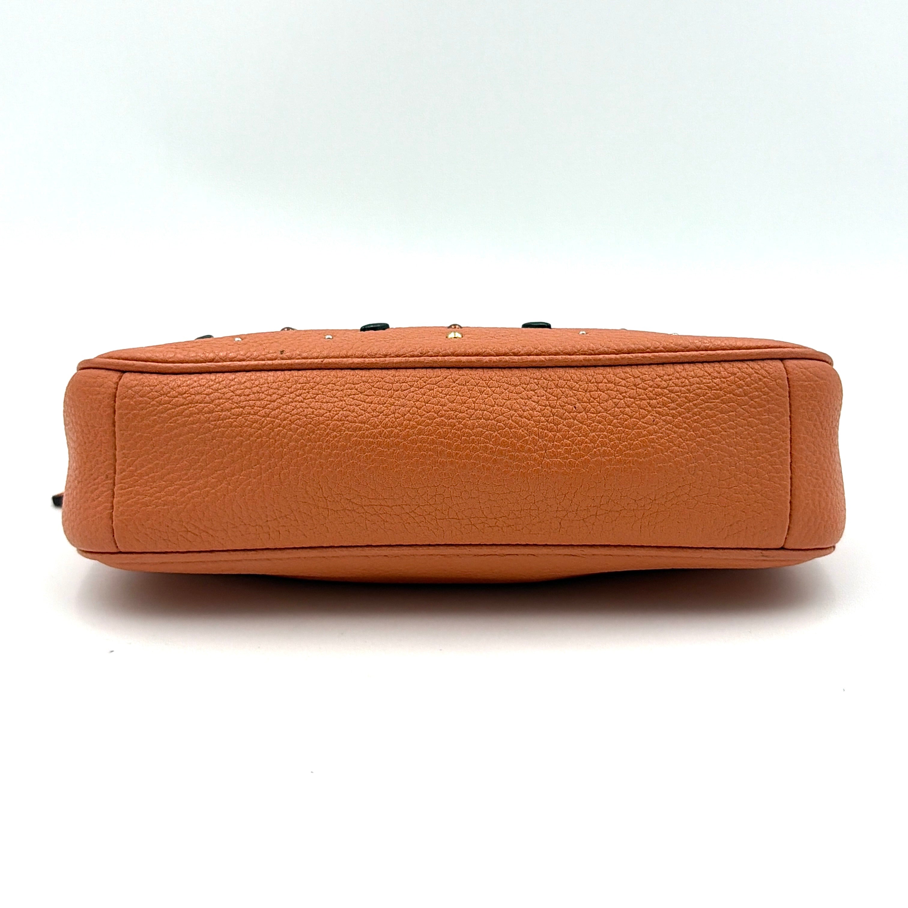 Coach Nolita 19 Prairie Rivets Shoulder Bag in bold orange pebbled leather with mixed metal rivet embellishments and chunky chain strap.