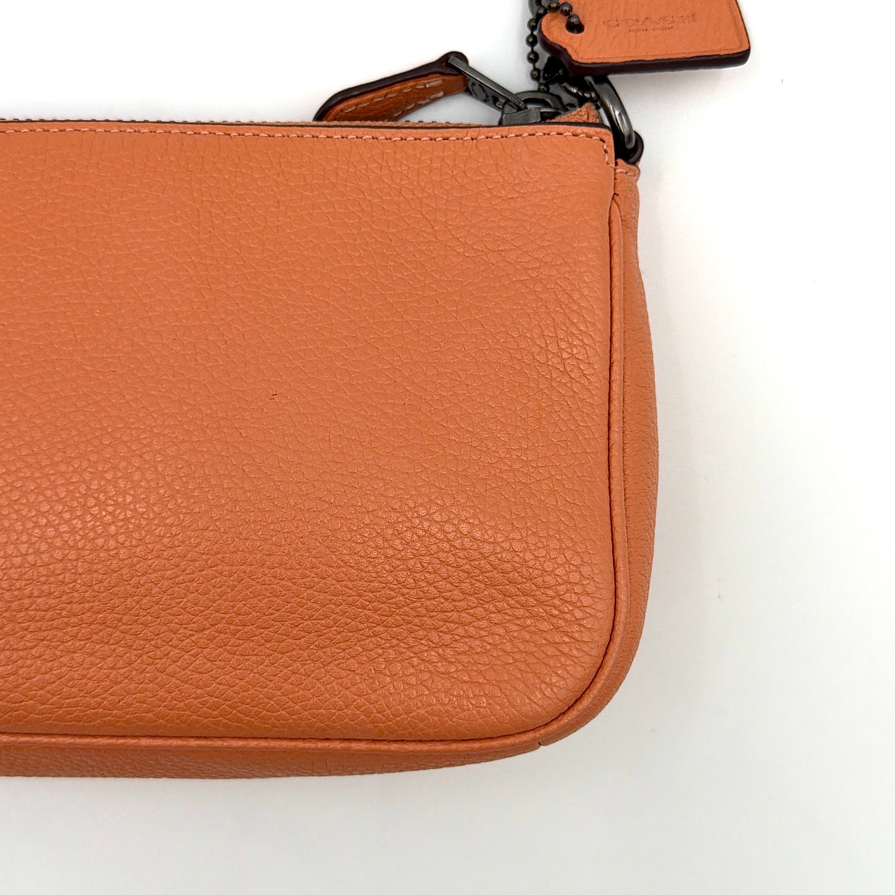 Coach Nolita 19 Prairie Rivets Shoulder Bag in bold orange pebbled leather with mixed metal rivet embellishments and chunky chain strap.