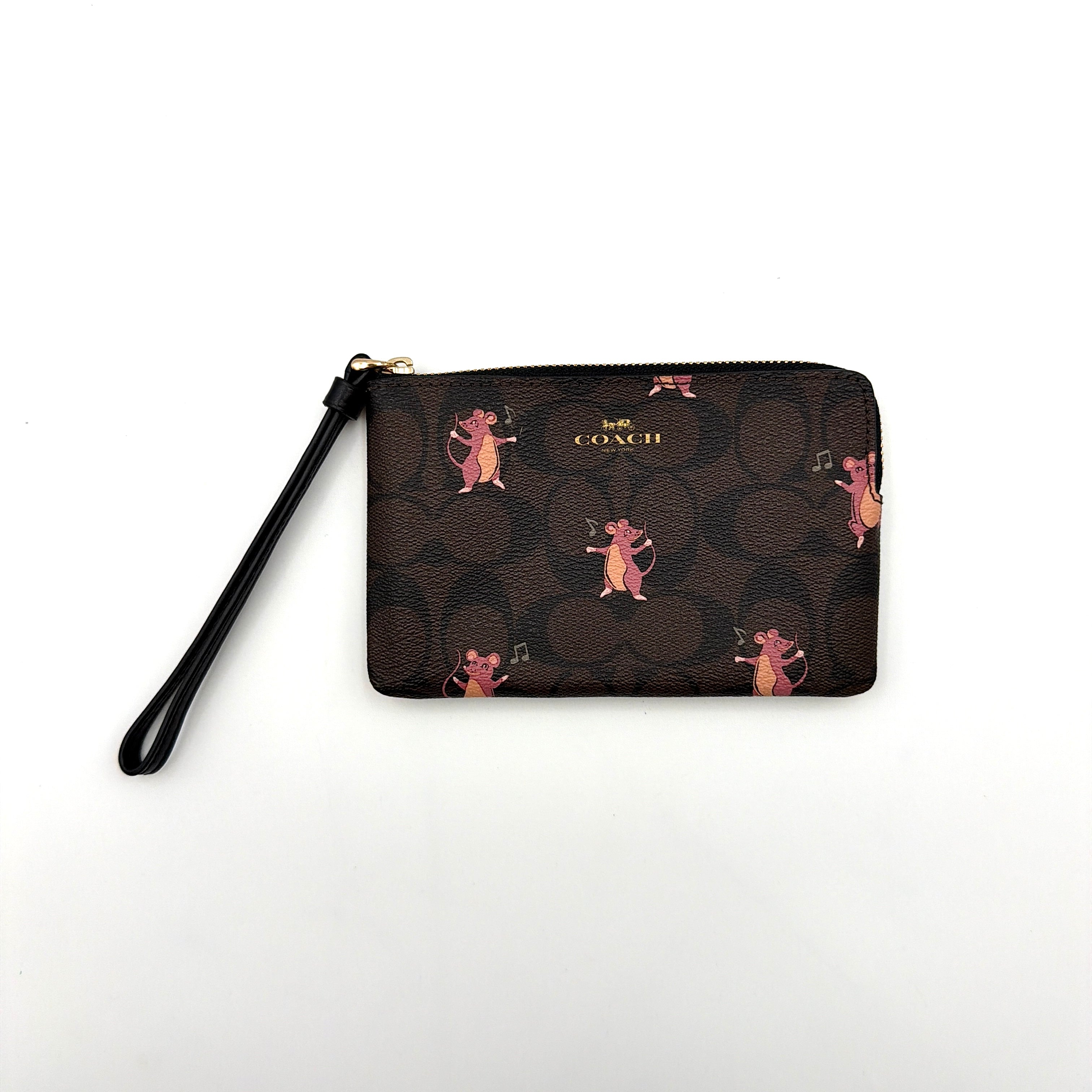 Coach Party Mouse Corner Zip Wristlet in brown canvas, featuring playful pink mouse illustrations and a black leather wrist strap.