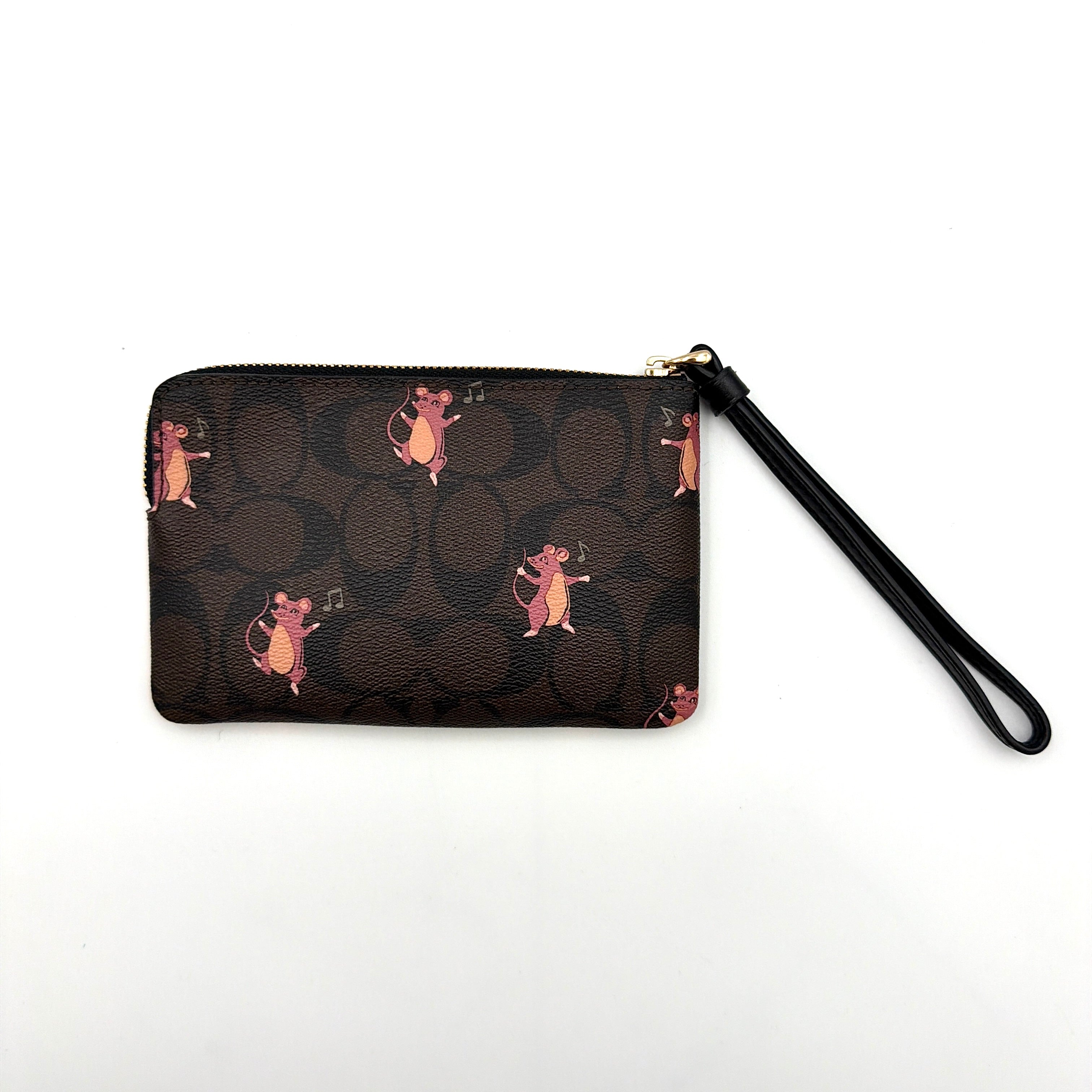 Coach Party Mouse Corner Zip Wristlet in brown canvas, featuring playful pink mouse illustrations and a black leather wrist strap.