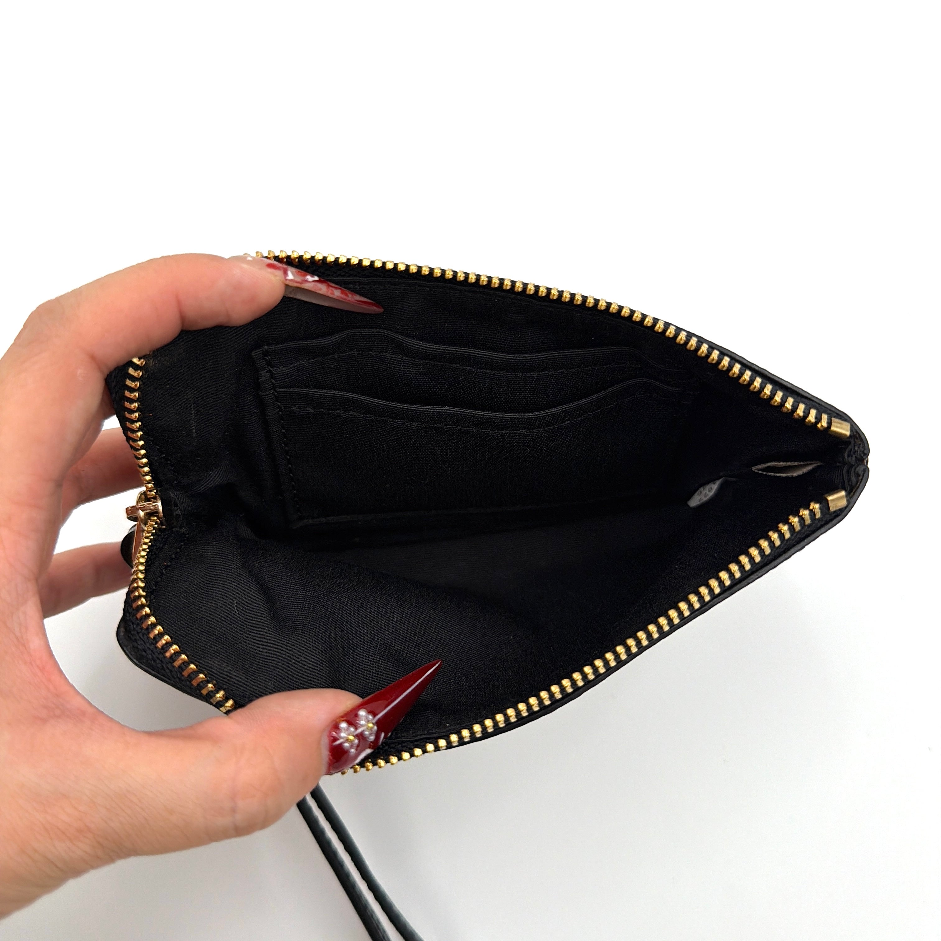 Coach Party Mouse Corner Zip Wristlet in brown canvas, featuring playful pink mouse illustrations and a black leather wrist strap.
