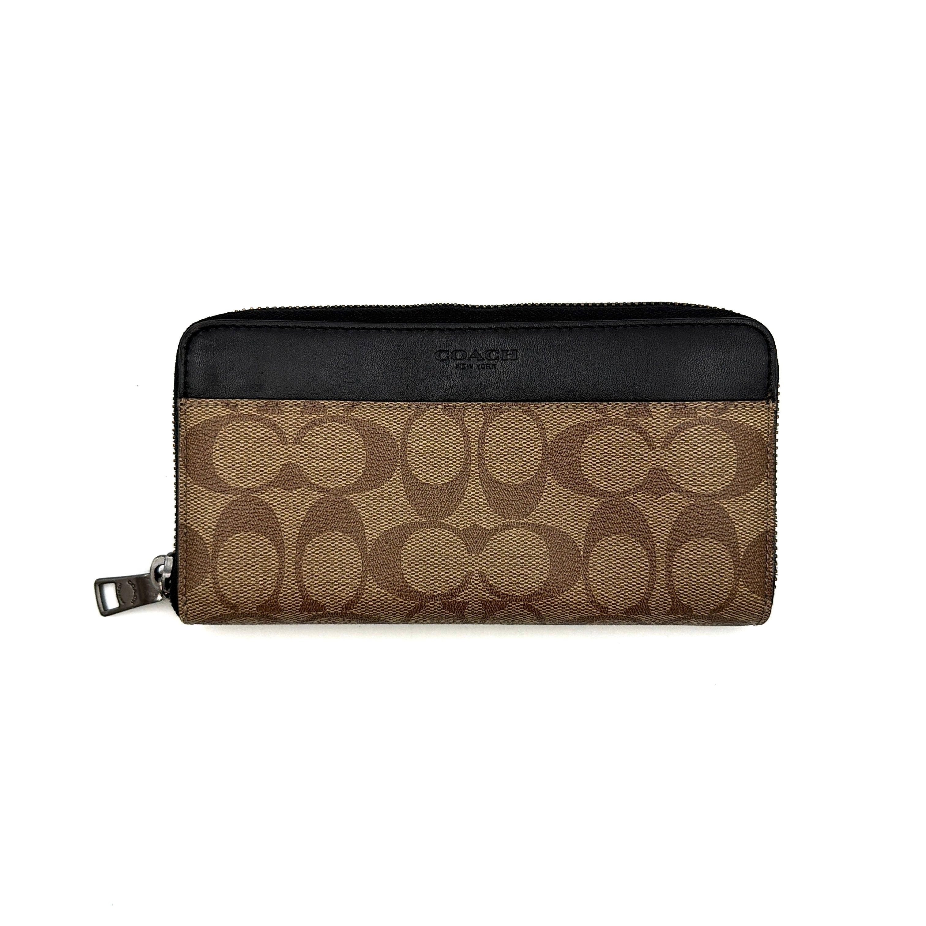 Coach Signature Accordion Long Wallet in beige and black canvas with black leather trim, featuring zip-around closure.