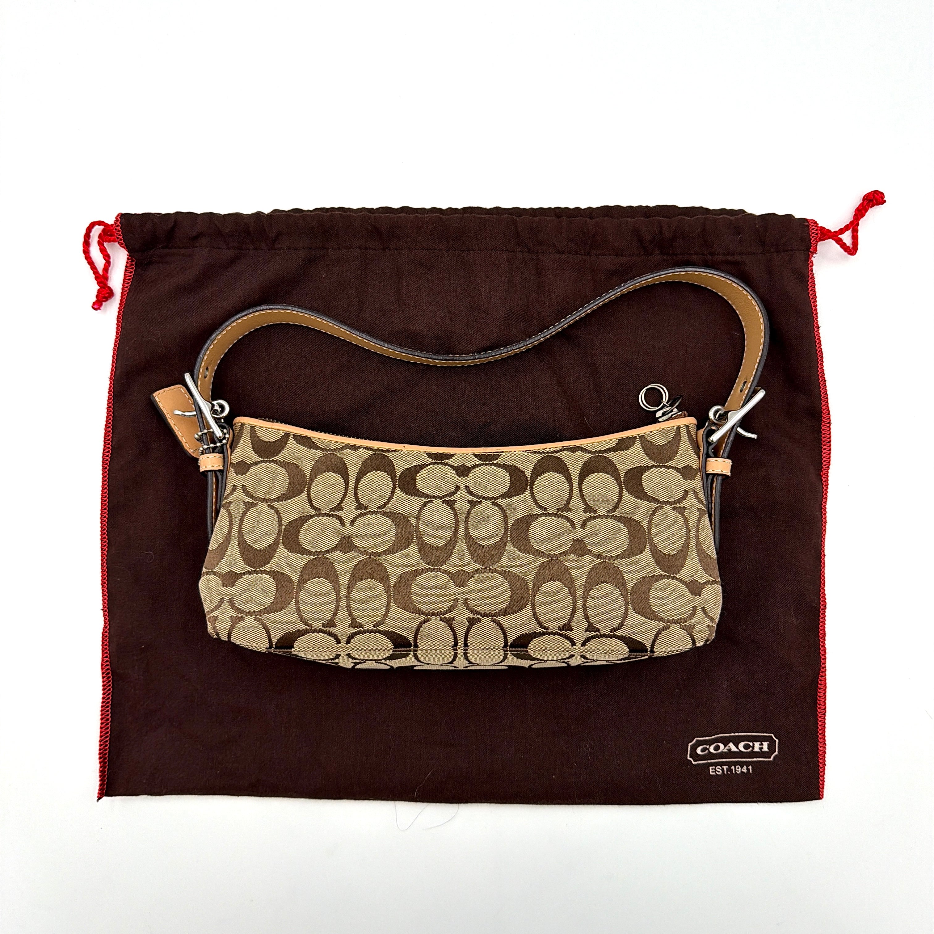 Coach Hamptons Demi Baguette shoulder bag in beige monogram canvas with tan leather trim and silver hardware.