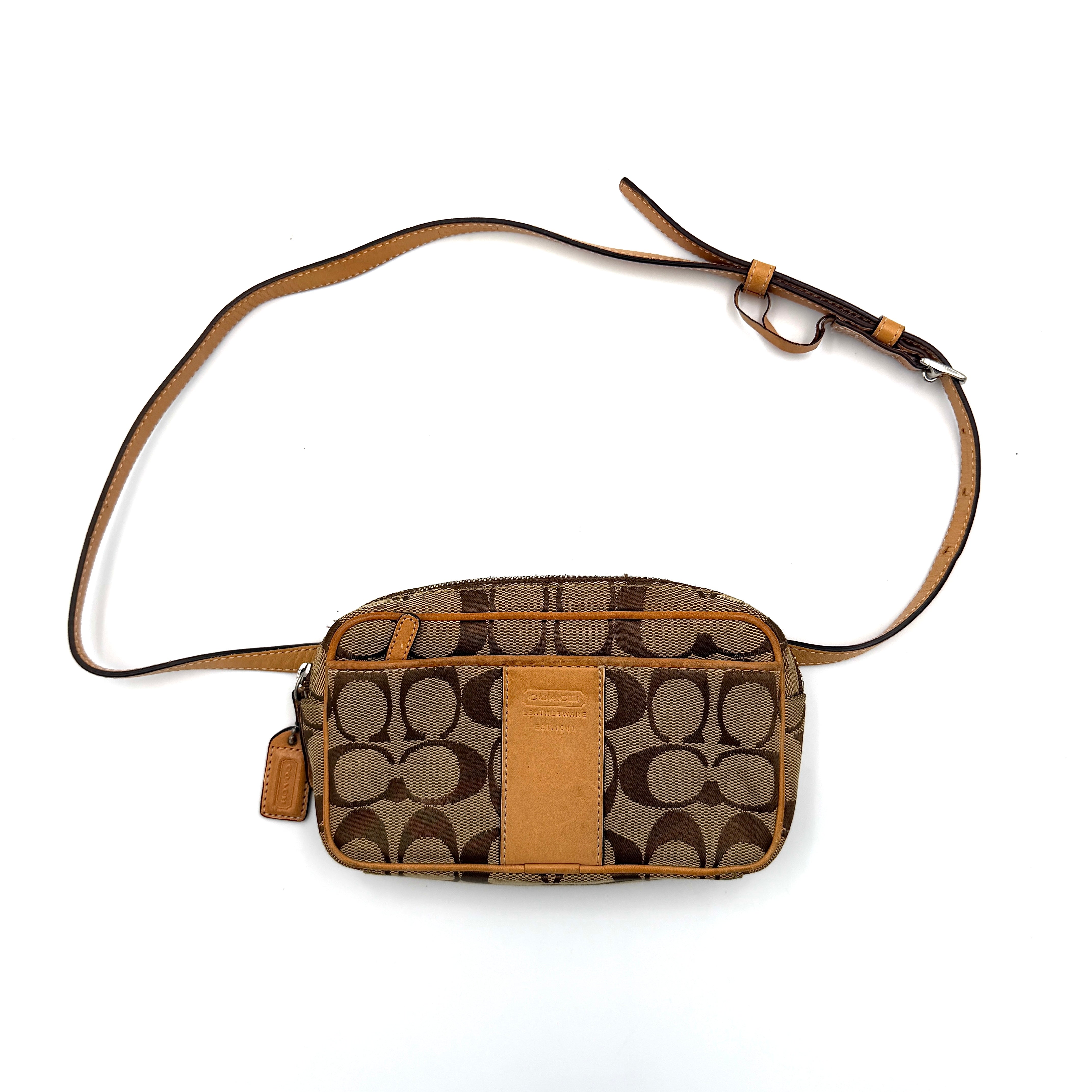 Coach Signature Canvas crossbody bag in beige and tan with iconic 'C' motif, natural leather trim and adjustable strap.