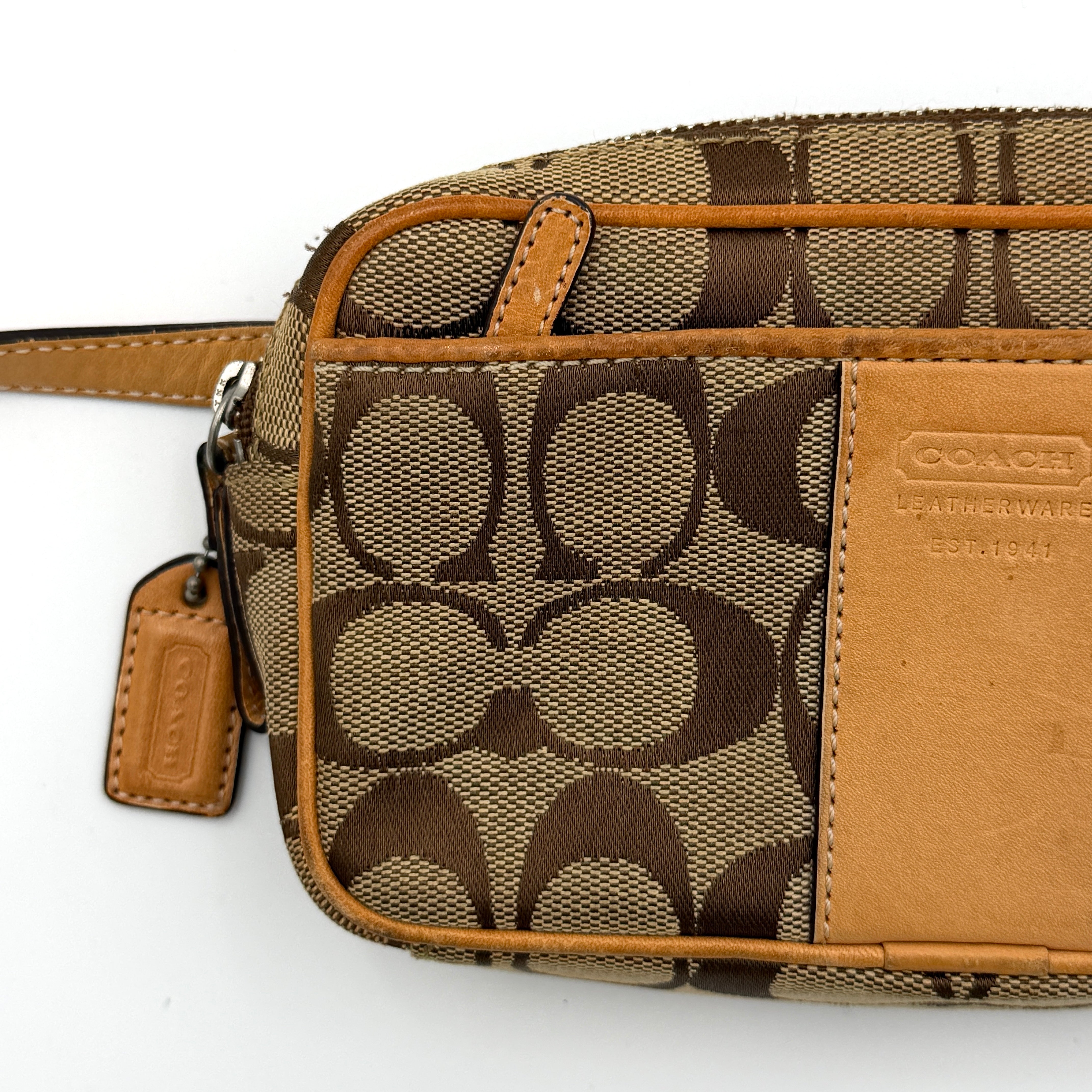 Coach Signature Canvas crossbody bag in beige and tan with iconic 'C' motif, natural leather trim and adjustable strap.