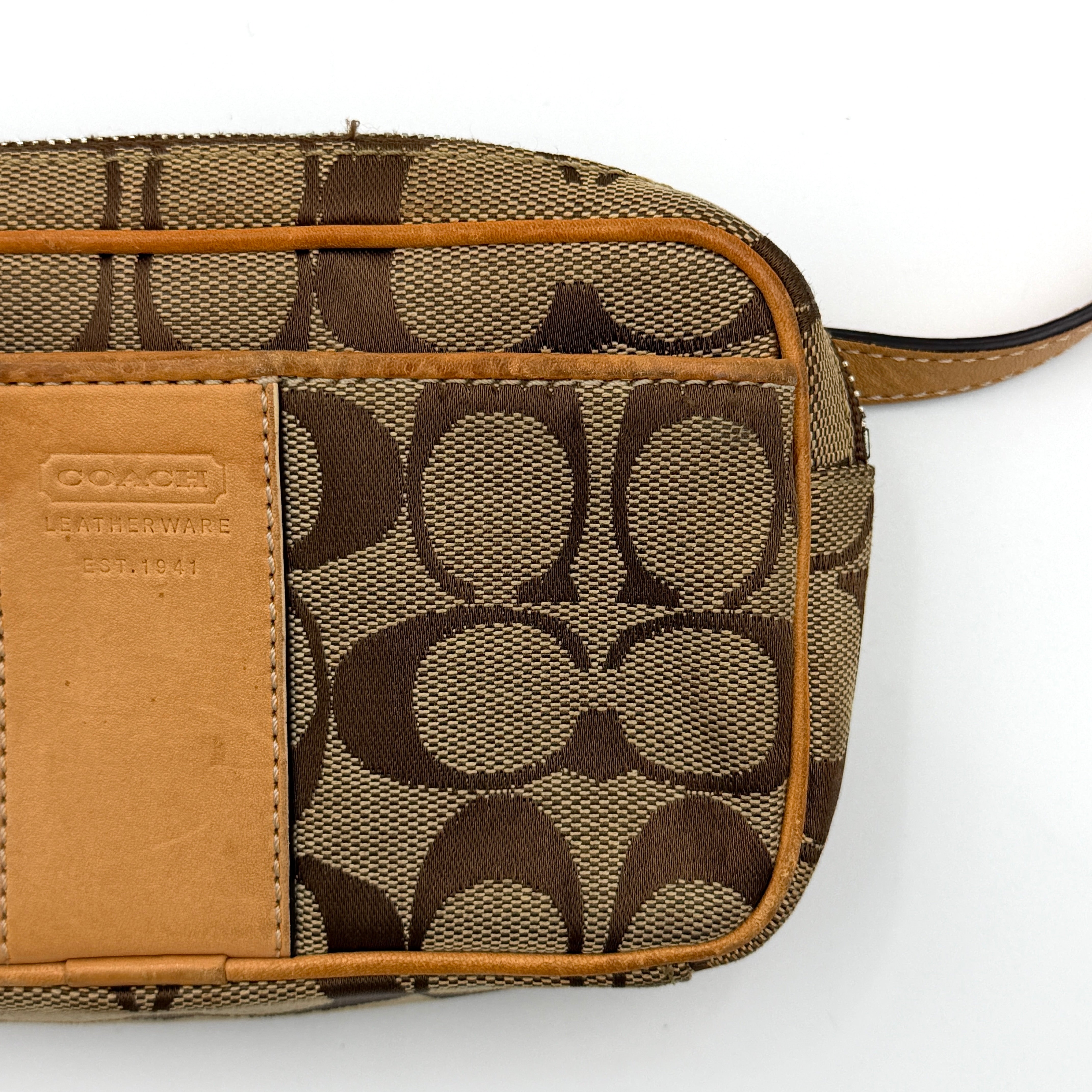 Coach Signature Canvas crossbody bag in beige and tan with iconic 'C' motif, natural leather trim and adjustable strap.