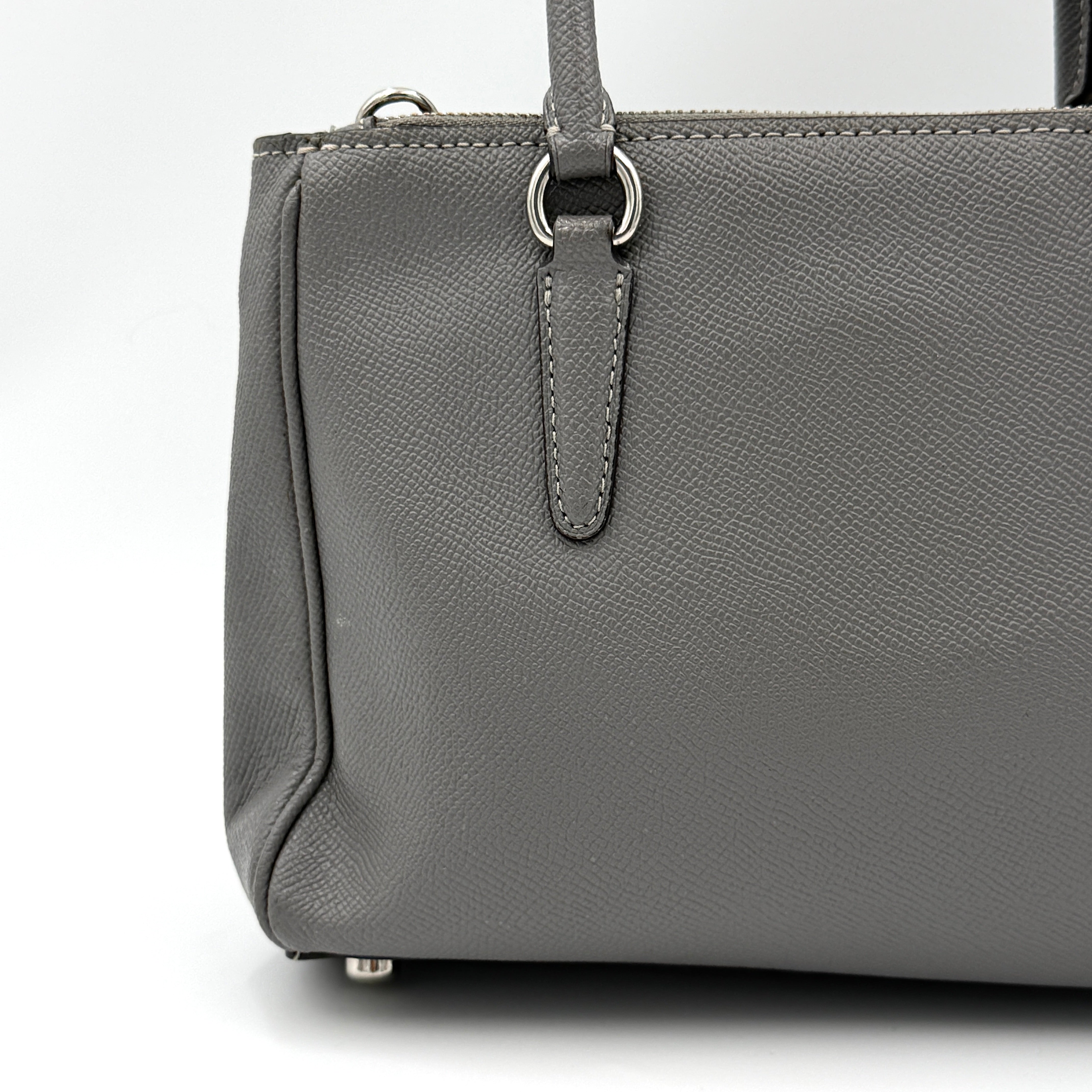 Coach 2Way Mini Surrey Carryall Handbag in grey textured leather with top handles and detachable strap, styled against a clean background.