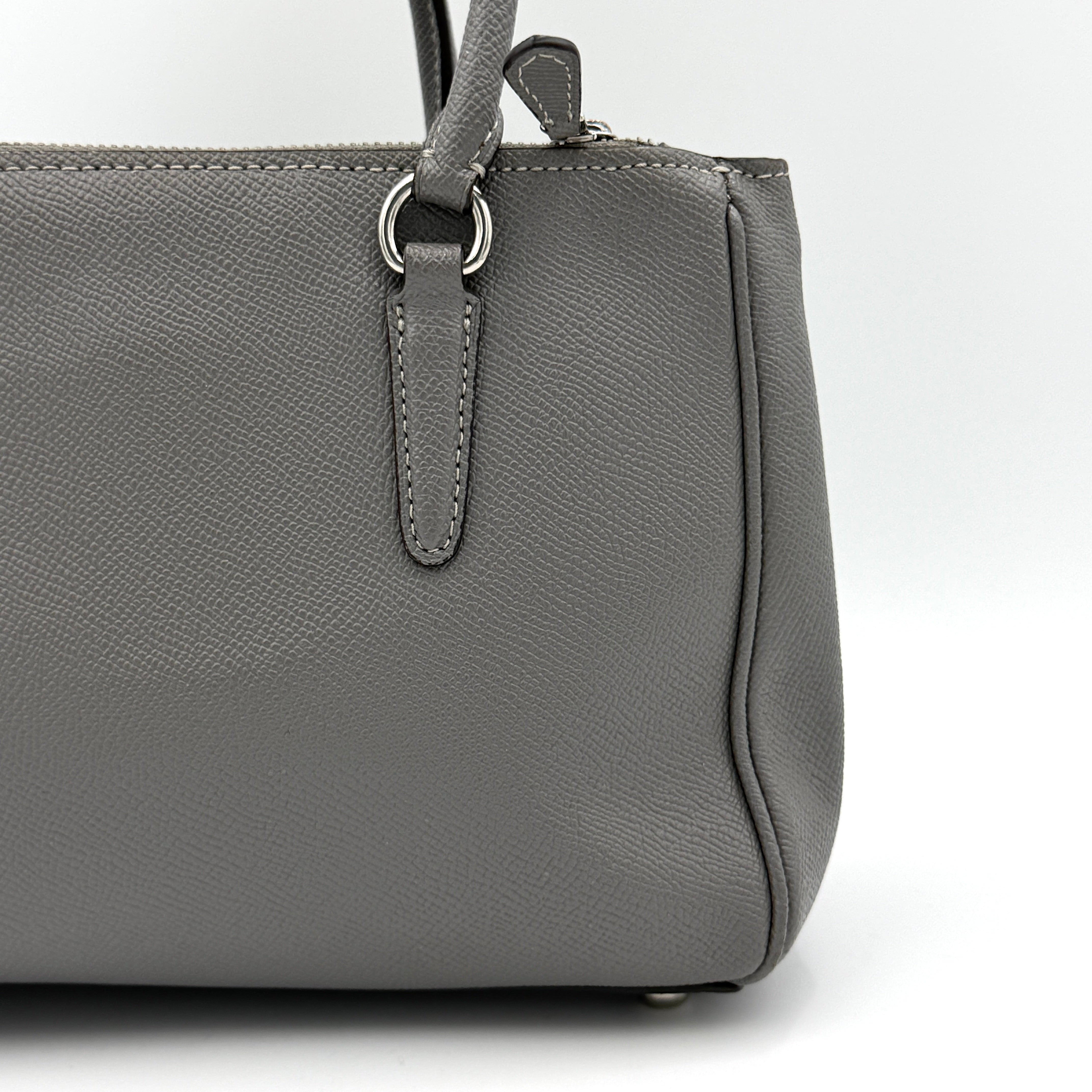 Coach 2Way Mini Surrey Carryall Handbag in grey textured leather with top handles and detachable strap, styled against a clean background.
