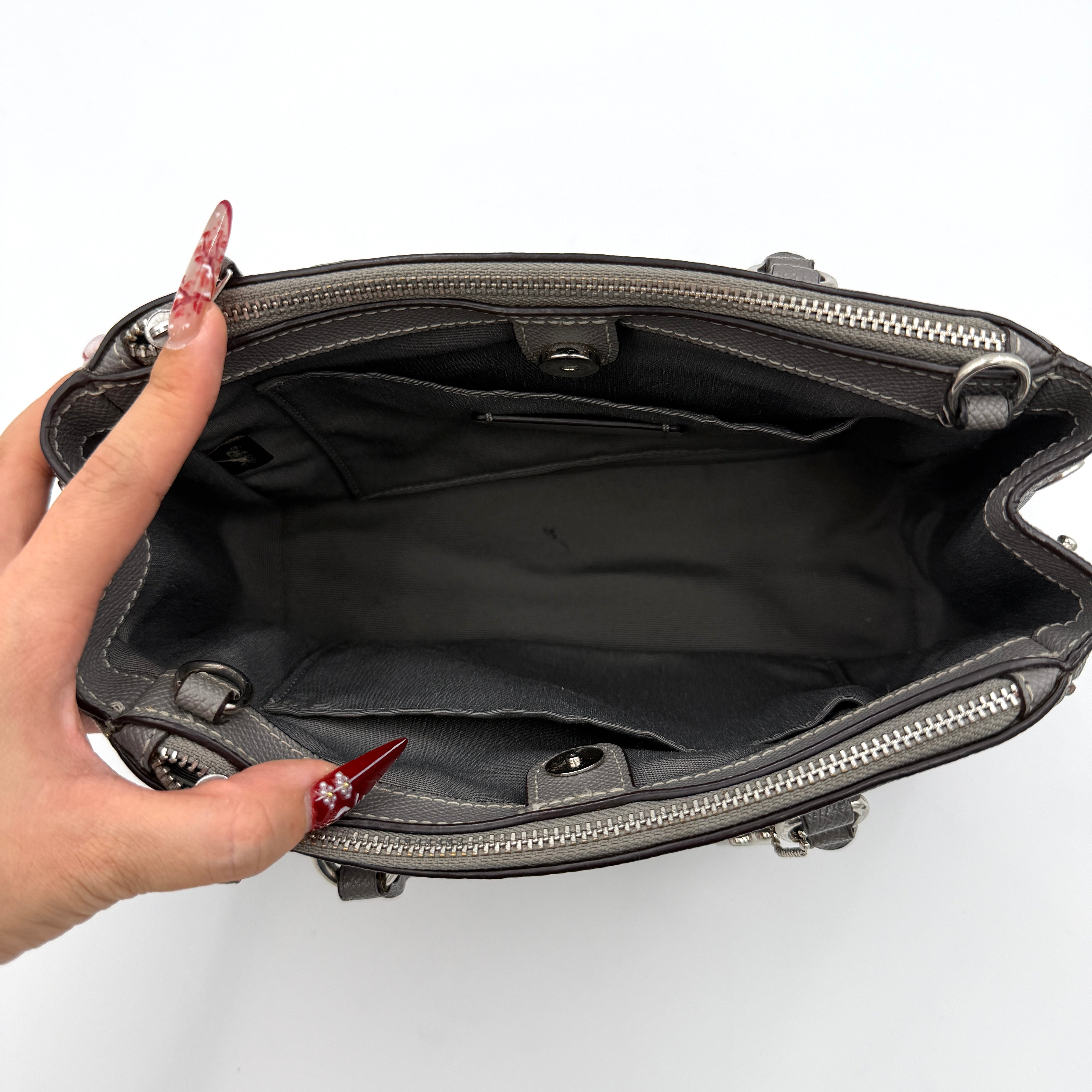 Coach 2Way Mini Surrey Carryall Handbag in grey textured leather with top handles and detachable strap, styled against a clean background.