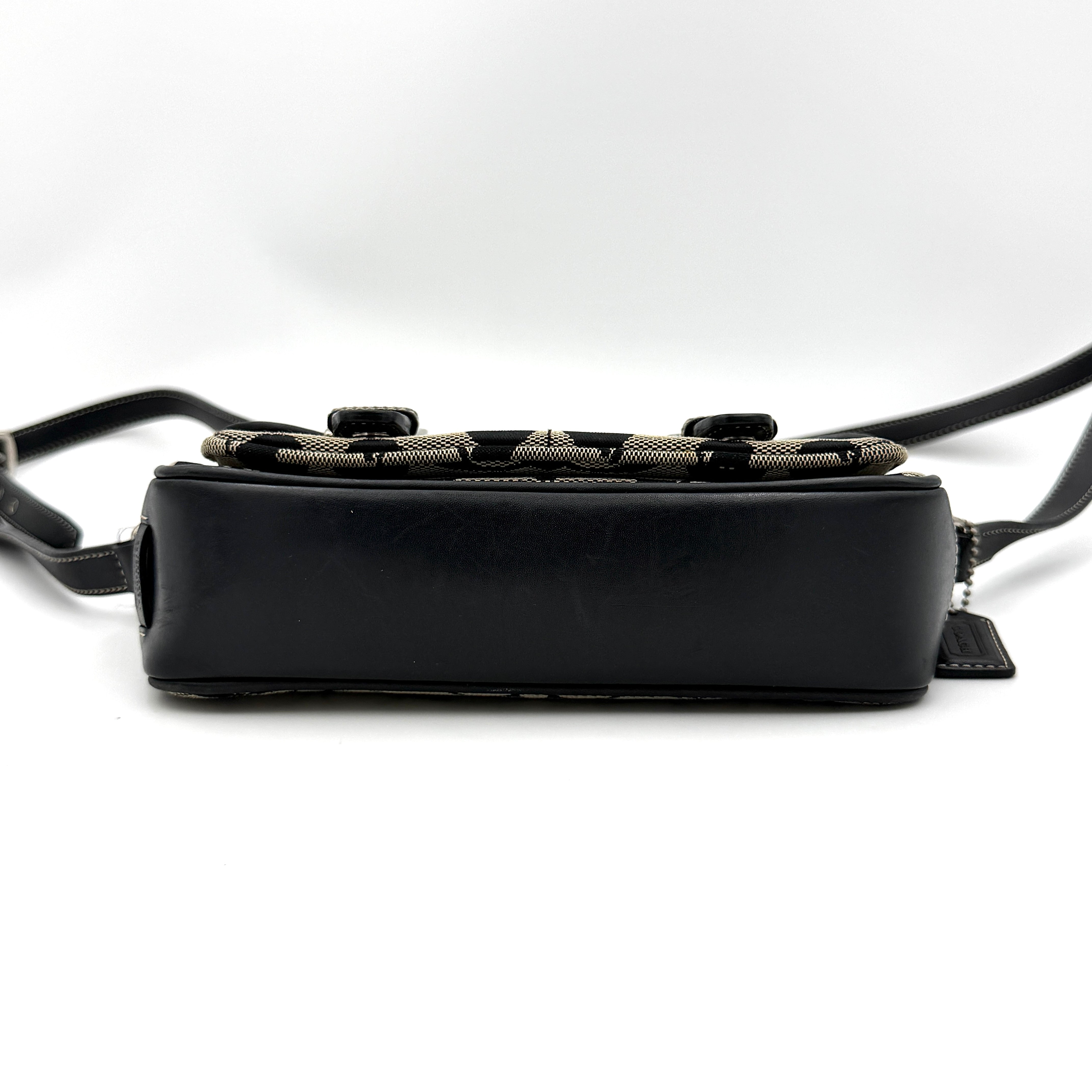 Coach Signature Double Buckle Crossbody bag in grey and black jacquard canvas, accented with black leather trim and dual silver-tone buckle detailing.