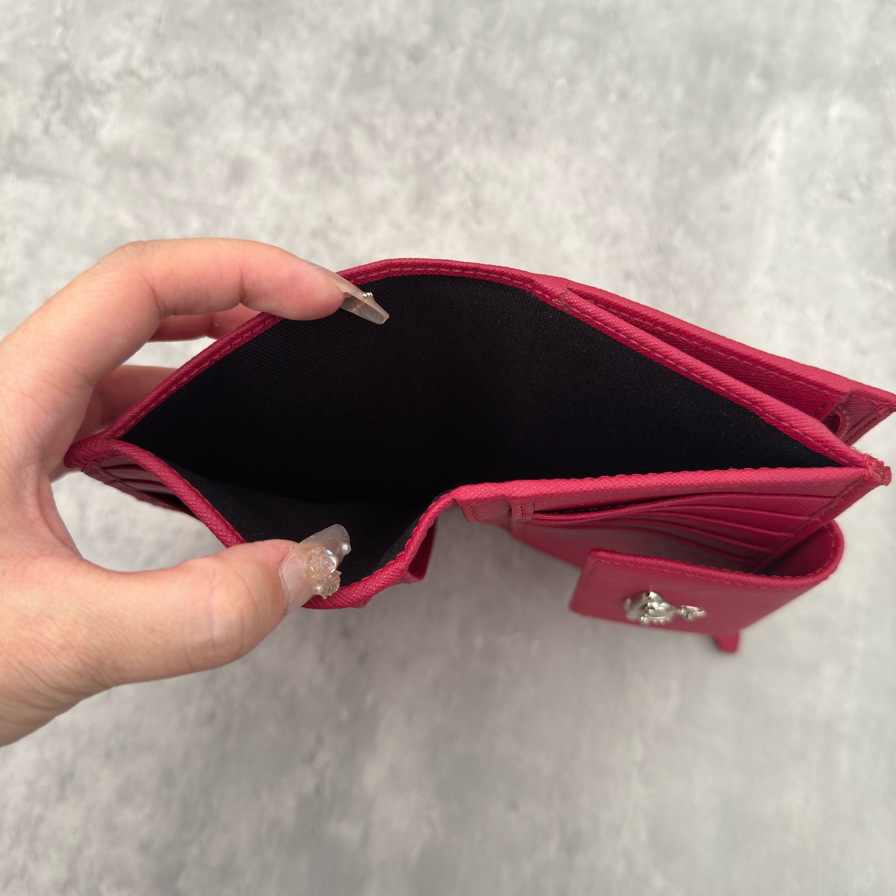 Vivienne Westwood Logo Orb Clip Wallet in Rose Pink Saffiano Leather with silver-tone emblem, card slots, and zippered coin pouch.