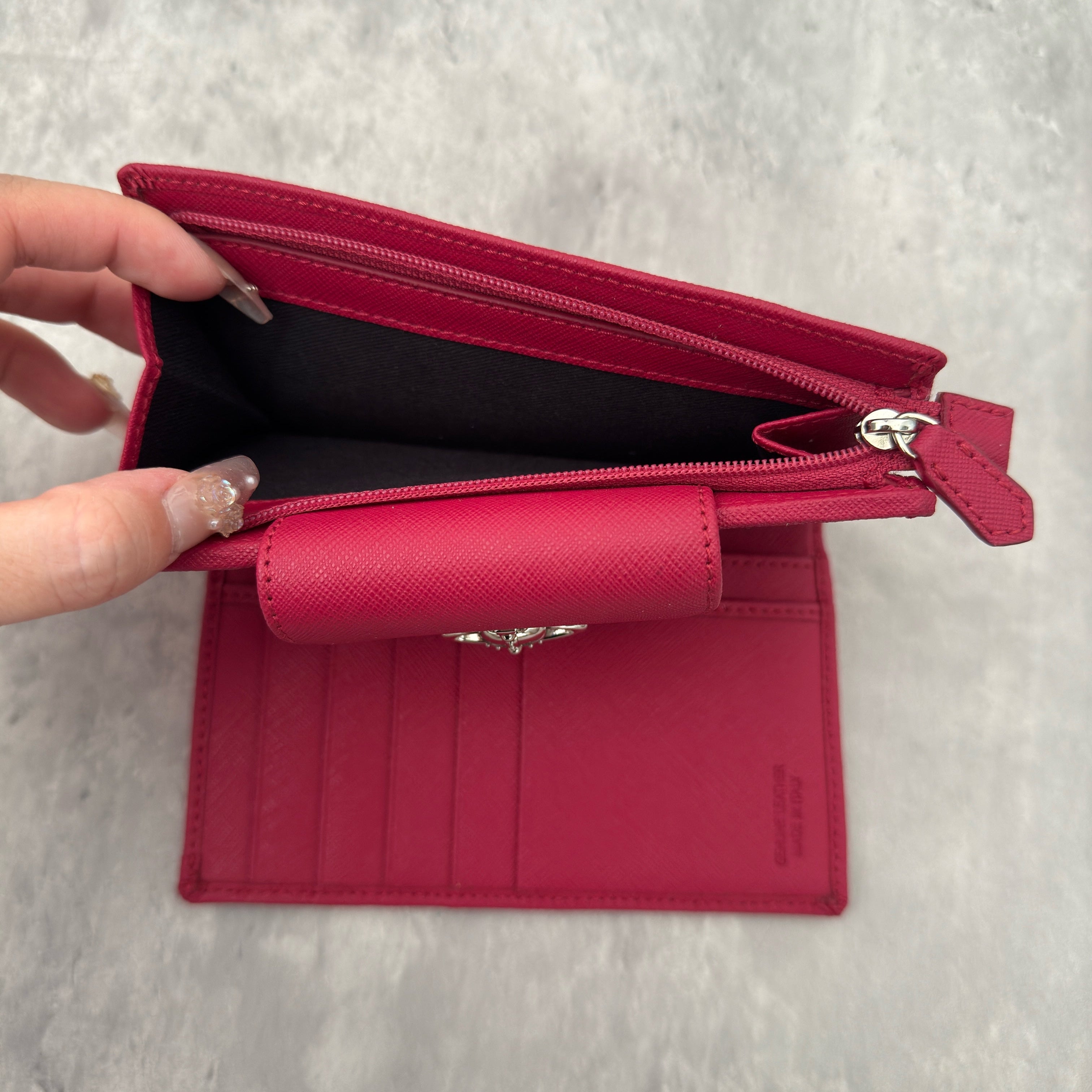 Vivienne Westwood Logo Orb Clip Wallet in Rose Pink Saffiano Leather with silver-tone emblem, card slots, and zippered coin pouch.