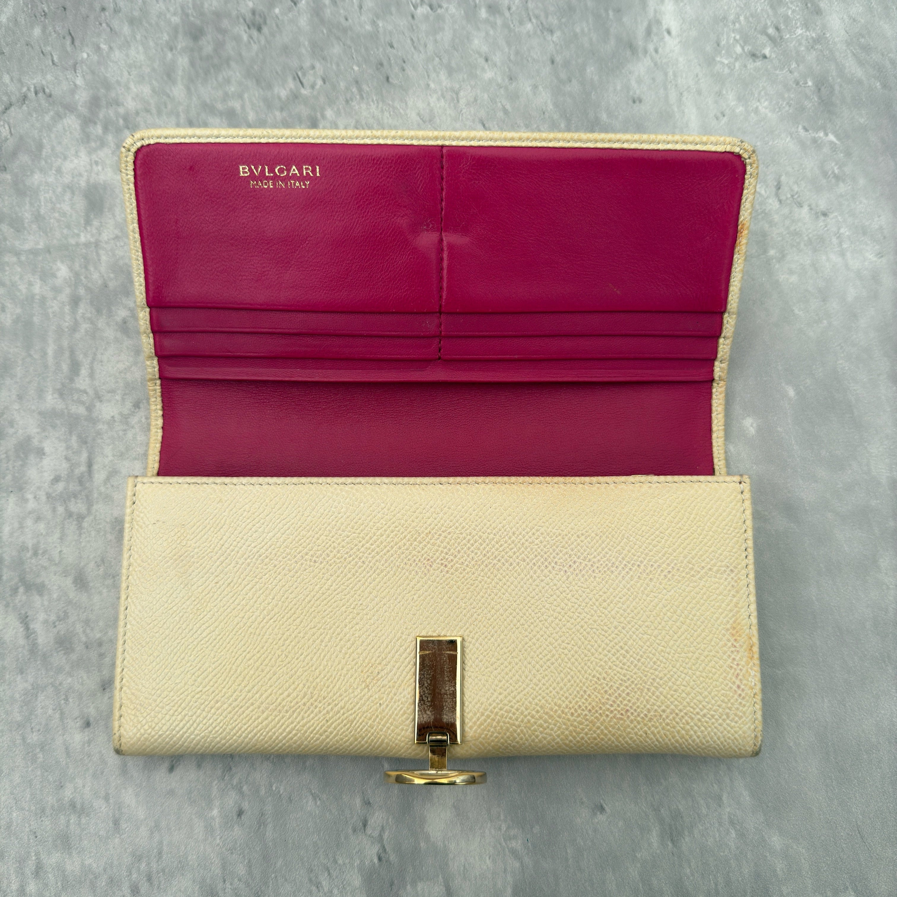 Bvlgari B.Zero1 Beige Saffiano Leather Long Wallet featuring a gold-tone ring clasp and fuchsia pink leather interior.