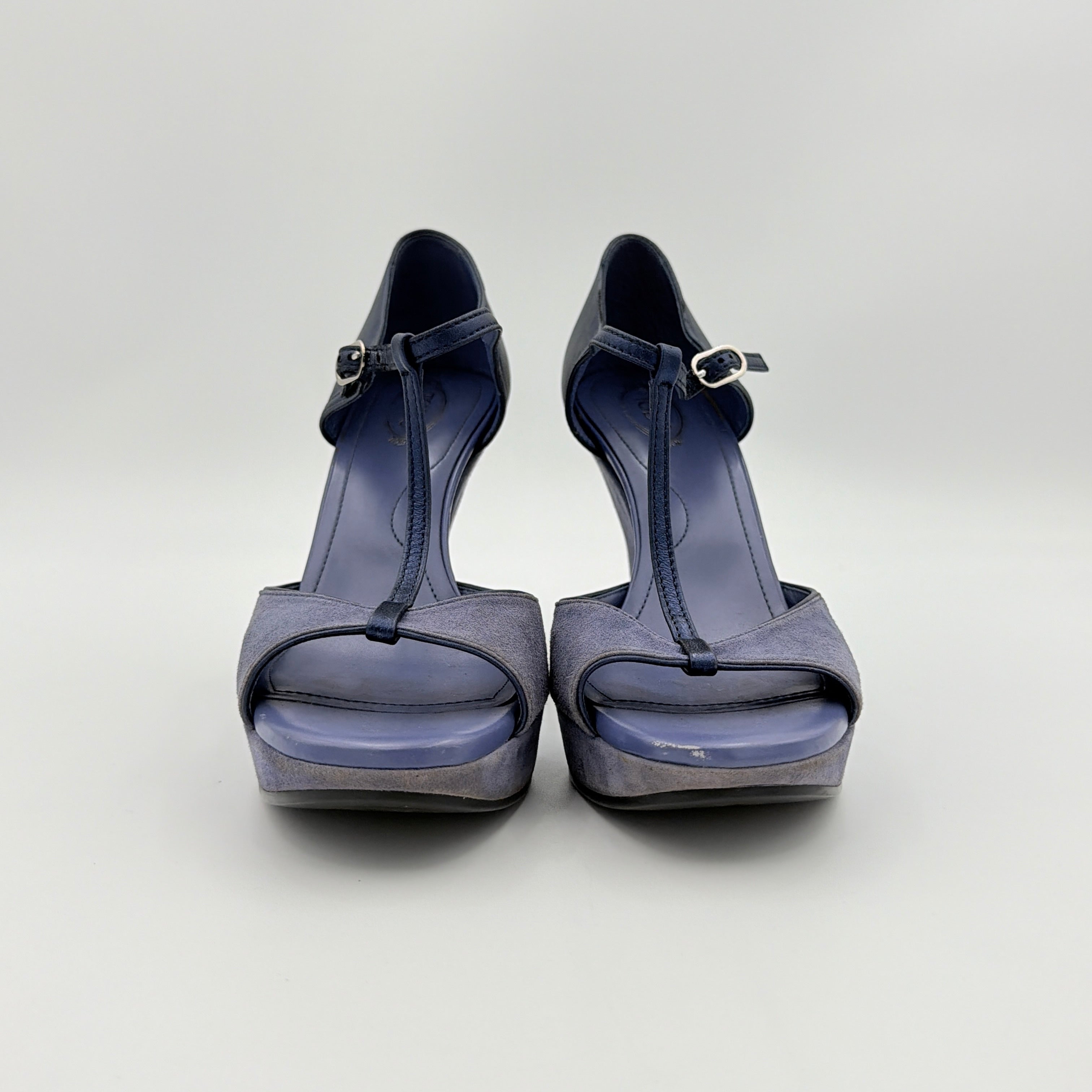 A pair of Tod's blue suede and leather T-strap platform wedge sandals with buckle detail, displayed at an angle.