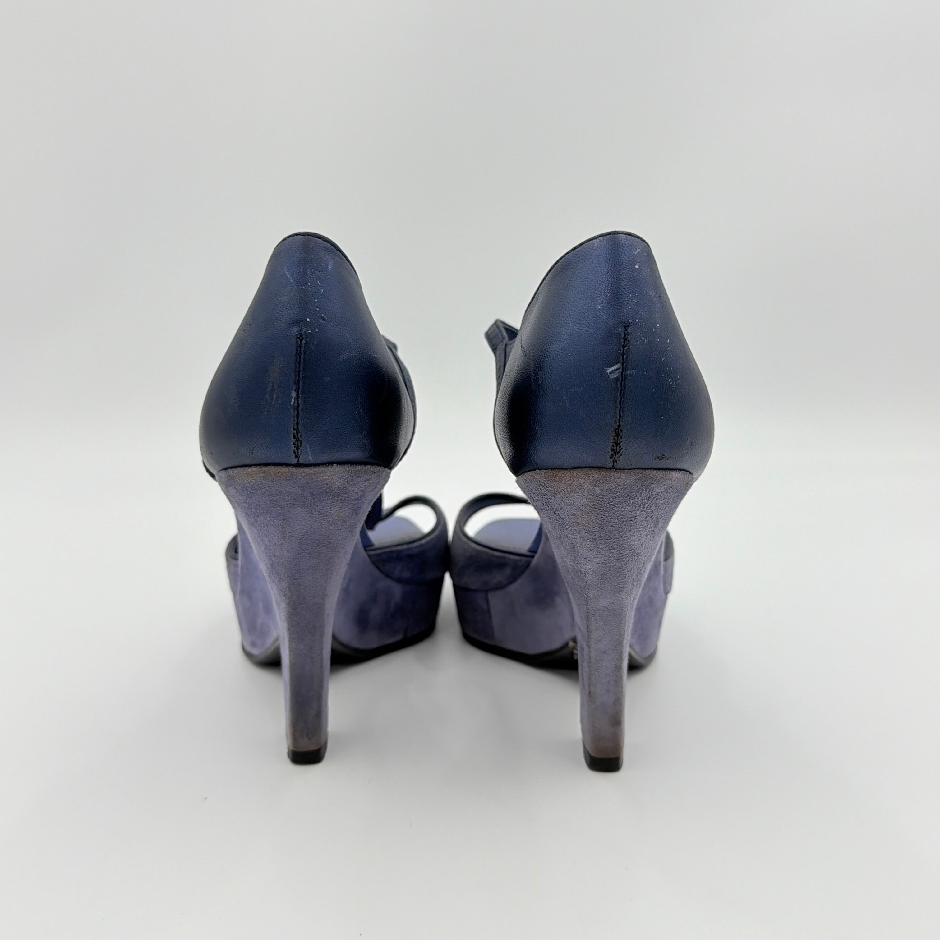 A pair of Tod's blue suede and leather T-strap platform wedge sandals with buckle detail, displayed at an angle.