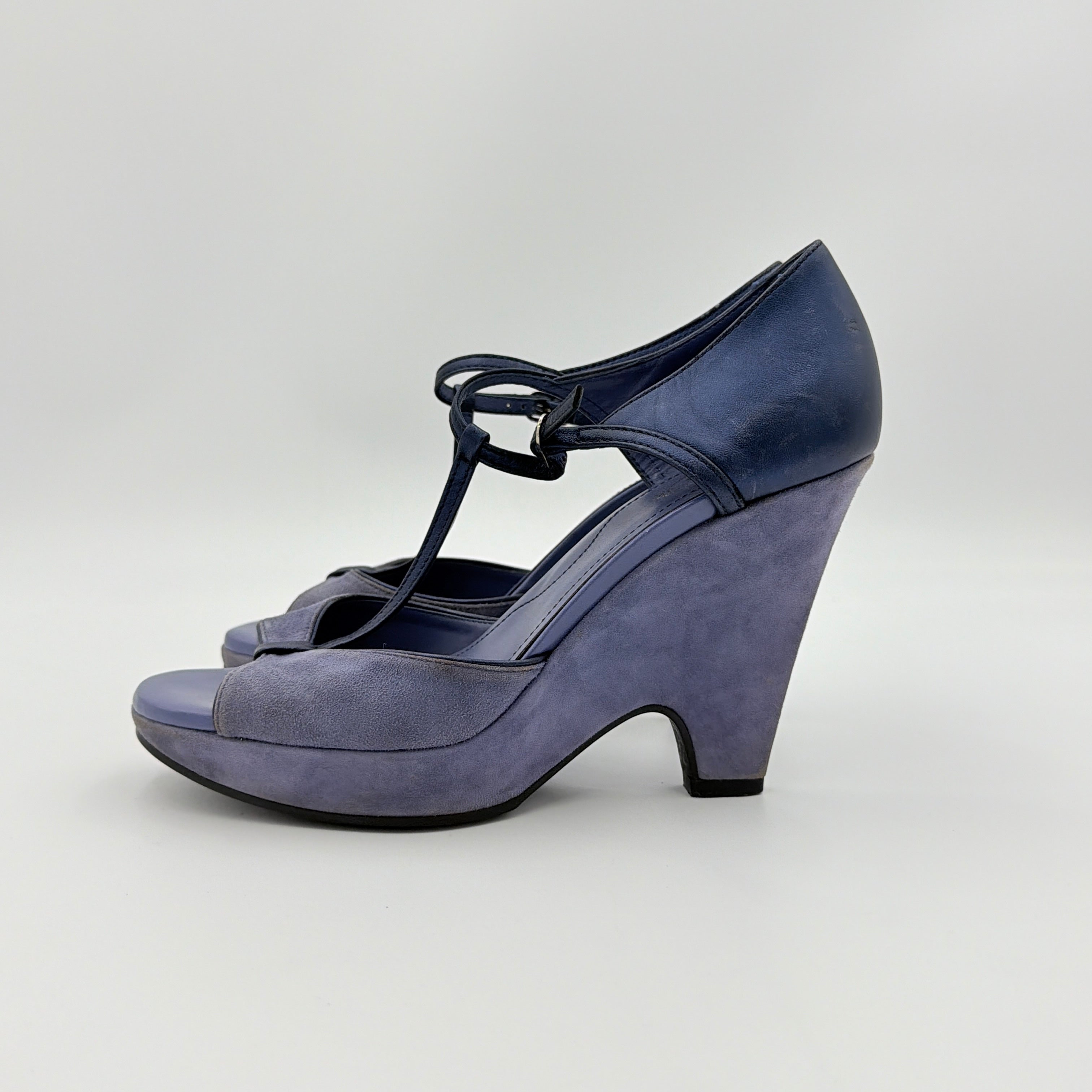 A pair of Tod's blue suede and leather T-strap platform wedge sandals with buckle detail, displayed at an angle.