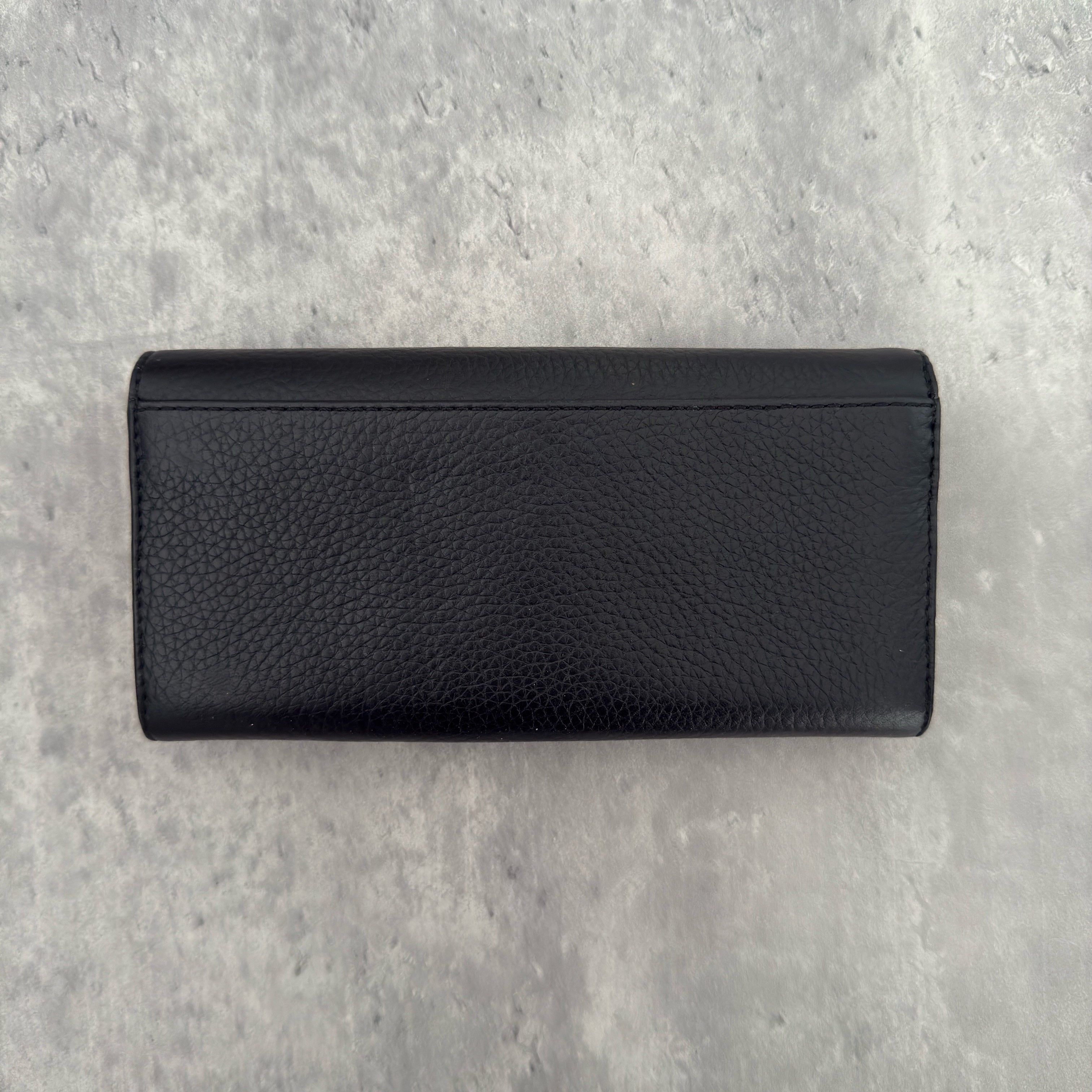 Michael Kors MK Gold Logo Bifold Long Wallet in black pebbled leather, featuring a structured silhouette with a gold-tone MK logo and a snap button closure.