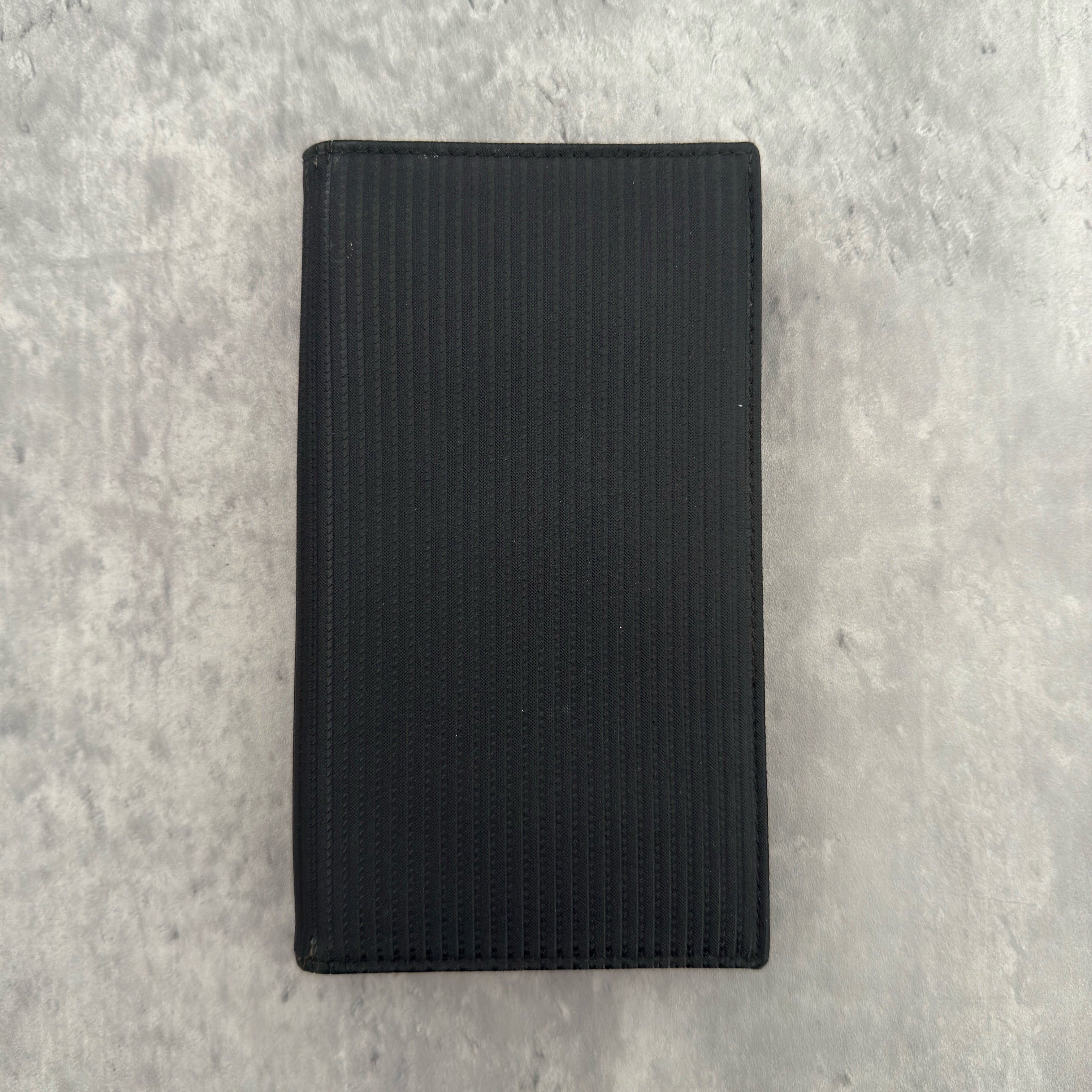 Bvlgari Ribbed Nylon Long Bifold Wallet in black with a silver-tone metal plaque logo, featuring multiple compartments and a sleek ribbed texture.
