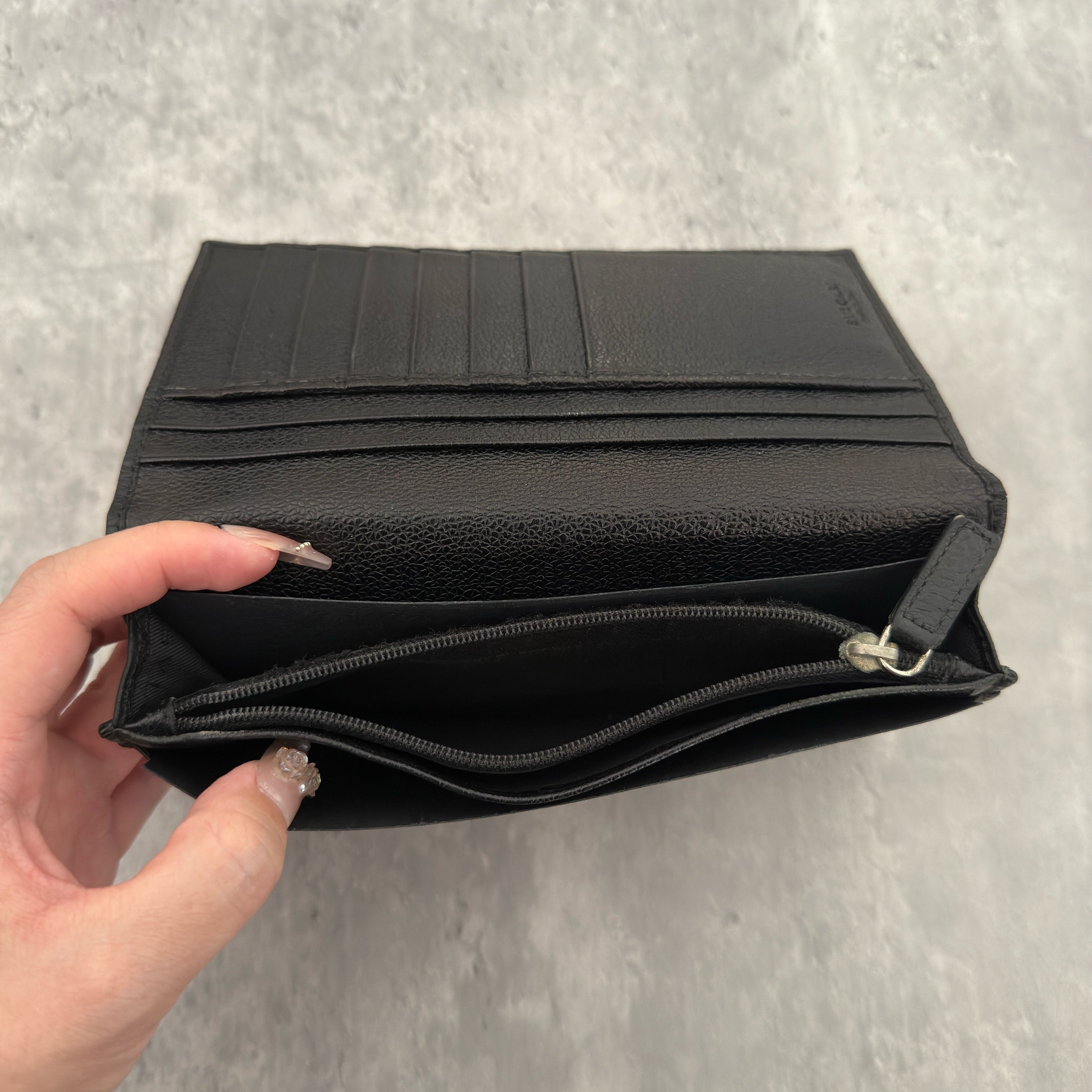 Bvlgari Ribbed Nylon Long Bifold Wallet in black with a silver-tone metal plaque logo, featuring multiple compartments and a sleek ribbed texture.