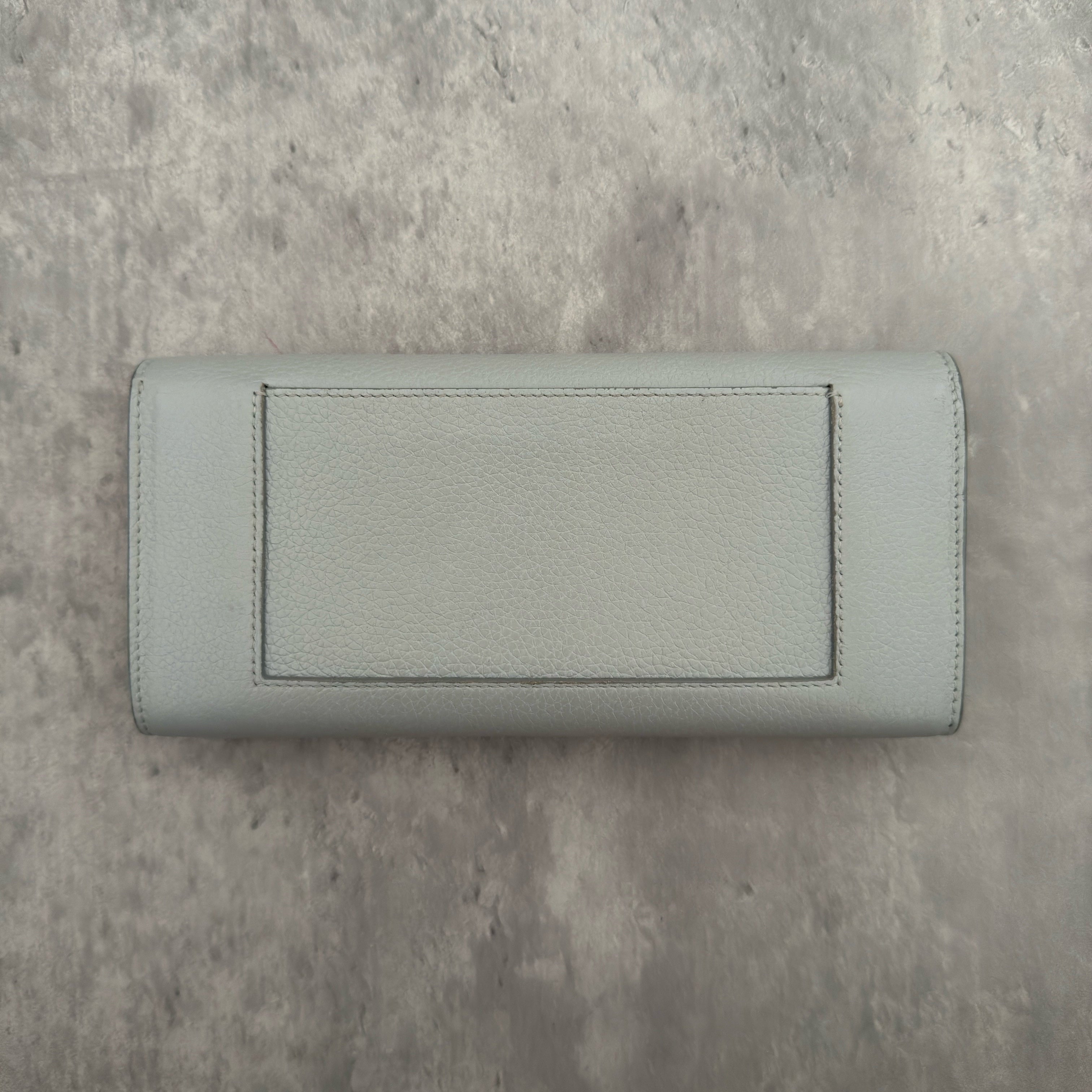 Celine Long Bifold Baby Blue Long Wallet, crafted from grained leather with a clipped button snap closure and spacious interior.