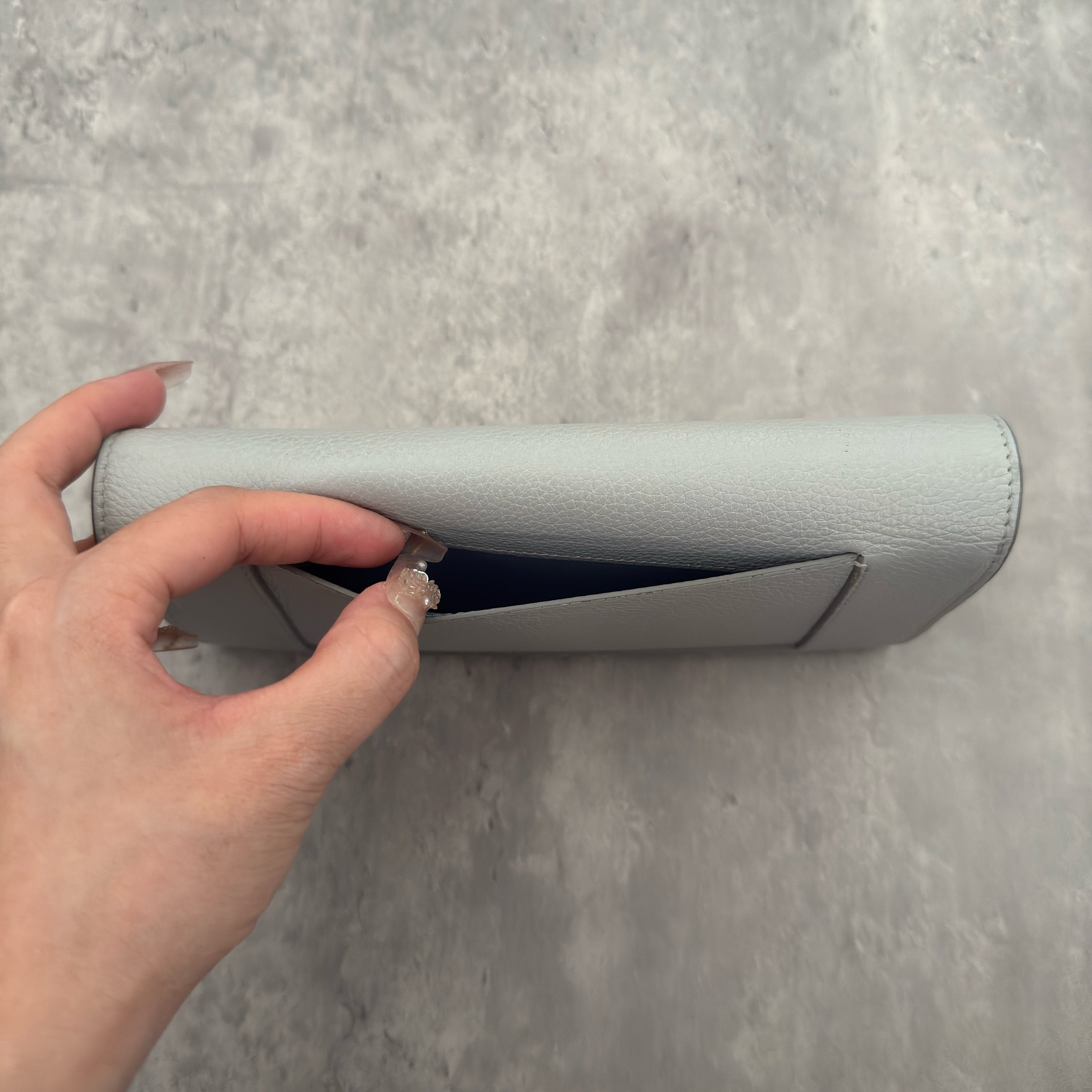 Celine Long Bifold Baby Blue Long Wallet, crafted from grained leather with a clipped button snap closure and spacious interior.