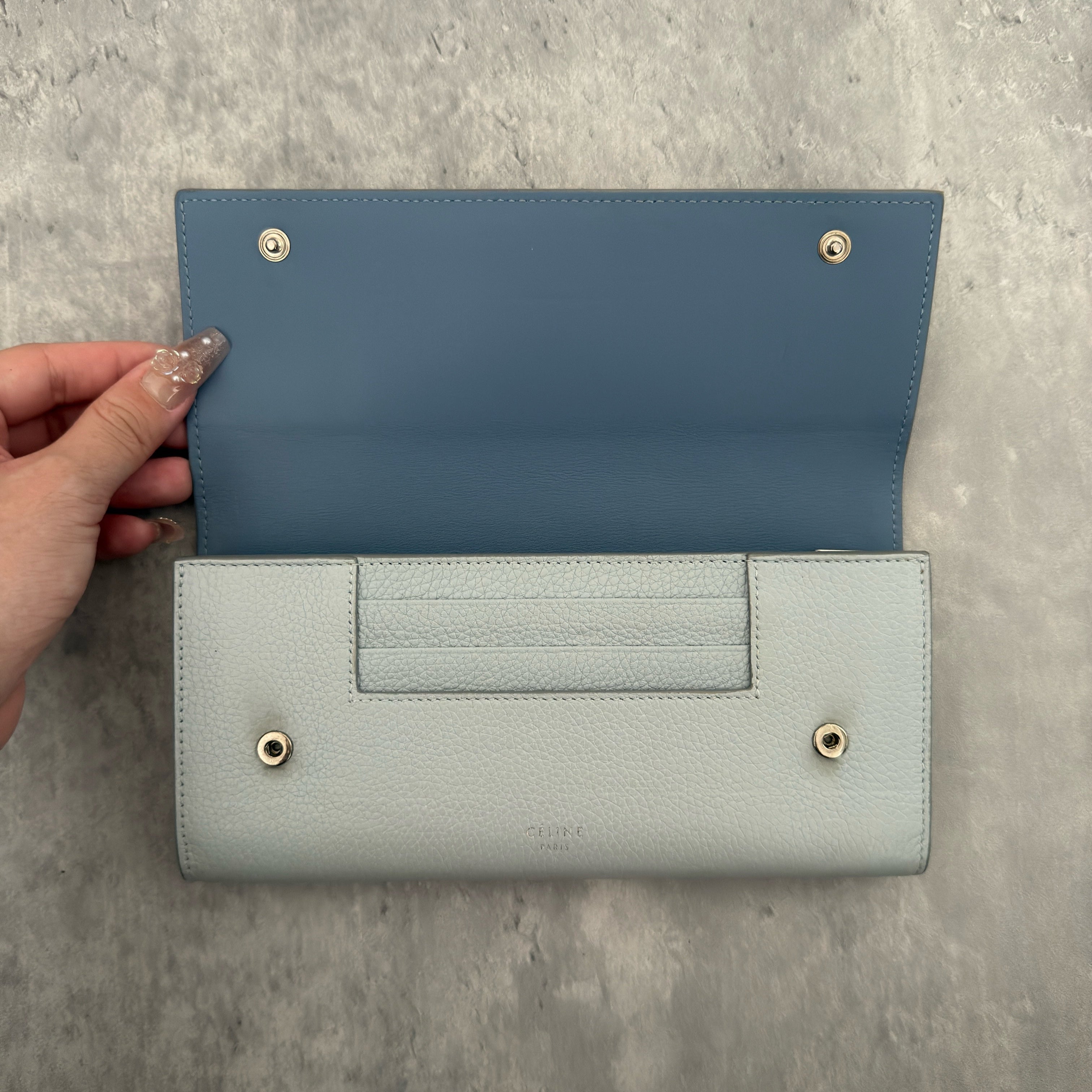 Celine Long Bifold Baby Blue Long Wallet, crafted from grained leather with a clipped button snap closure and spacious interior.