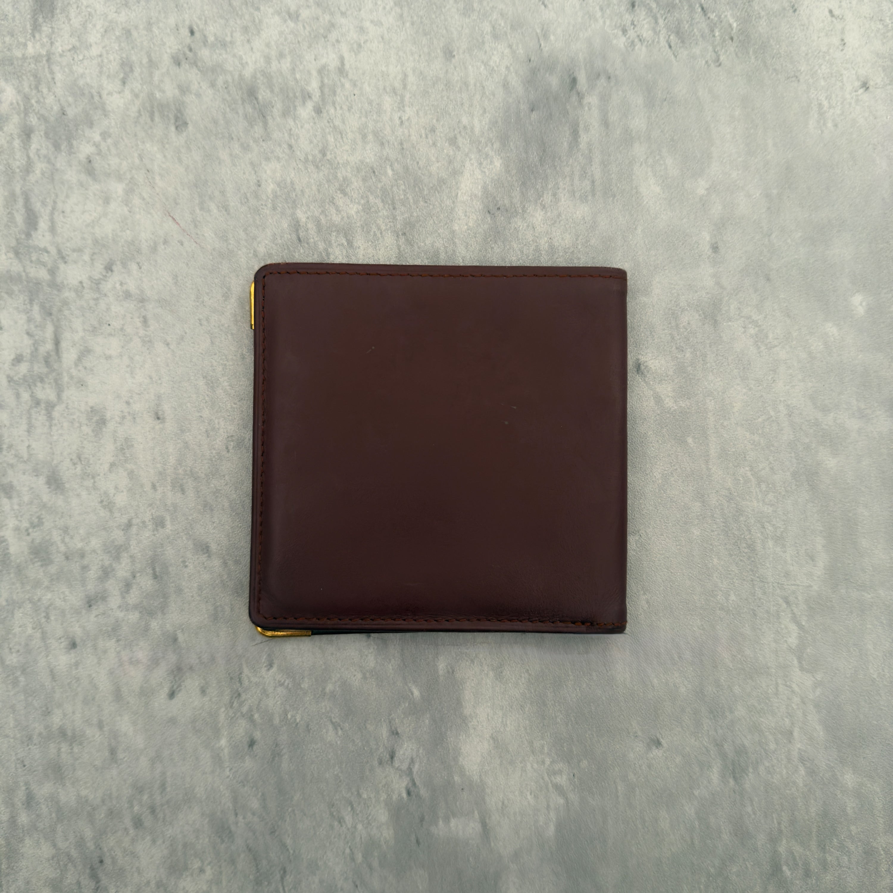 Cartier Mast Line Bordeaux Burgundy Wallet in premium leather, featuring gold-tone corner accents and embossed logo.