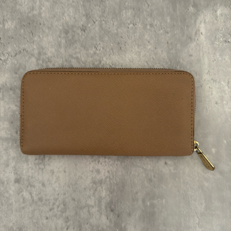 Michael Kors Jet Set Travel Zip-Around Saffiano Leather Continental Wallet in brown, featuring a gold-tone MK logo and zip-around closure.