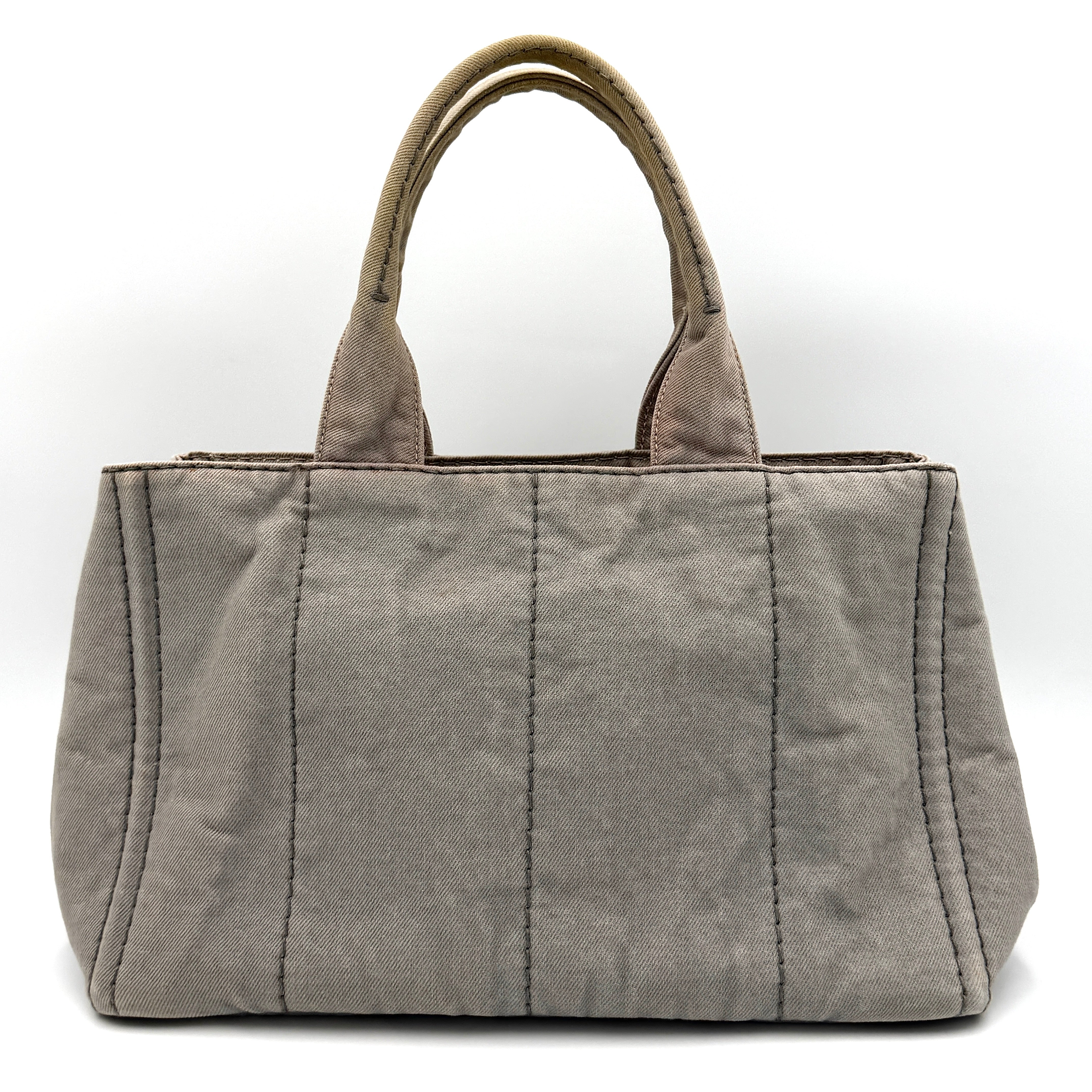Prada Canapa Tote Bag in grey canvas with rope logo motif and dual top handles against a plain background.