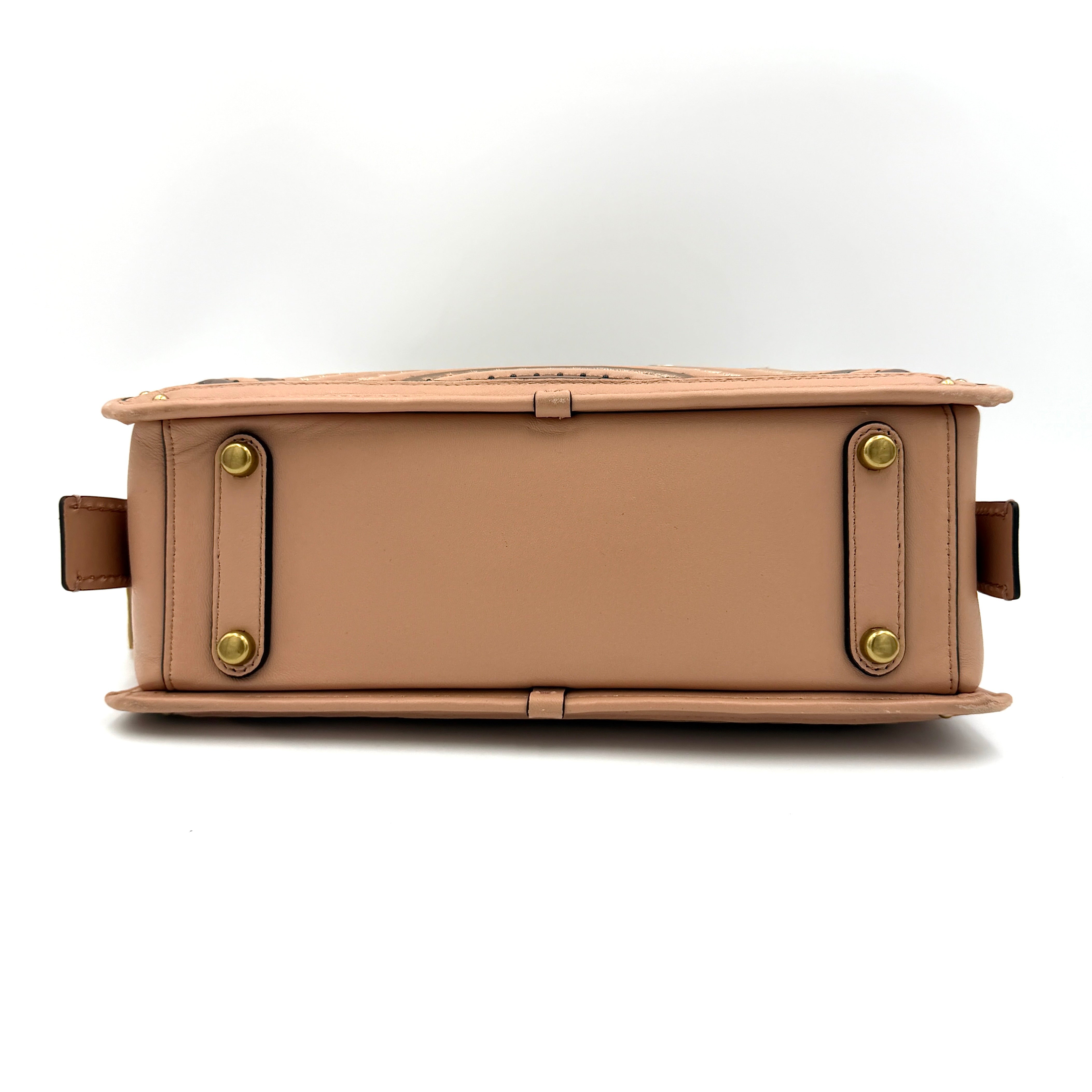 Coach Dreamer 27 handbag in nude pink leather with Deco quilting, gold rivets, and detachable strap, displayed elegantly on a plain background.