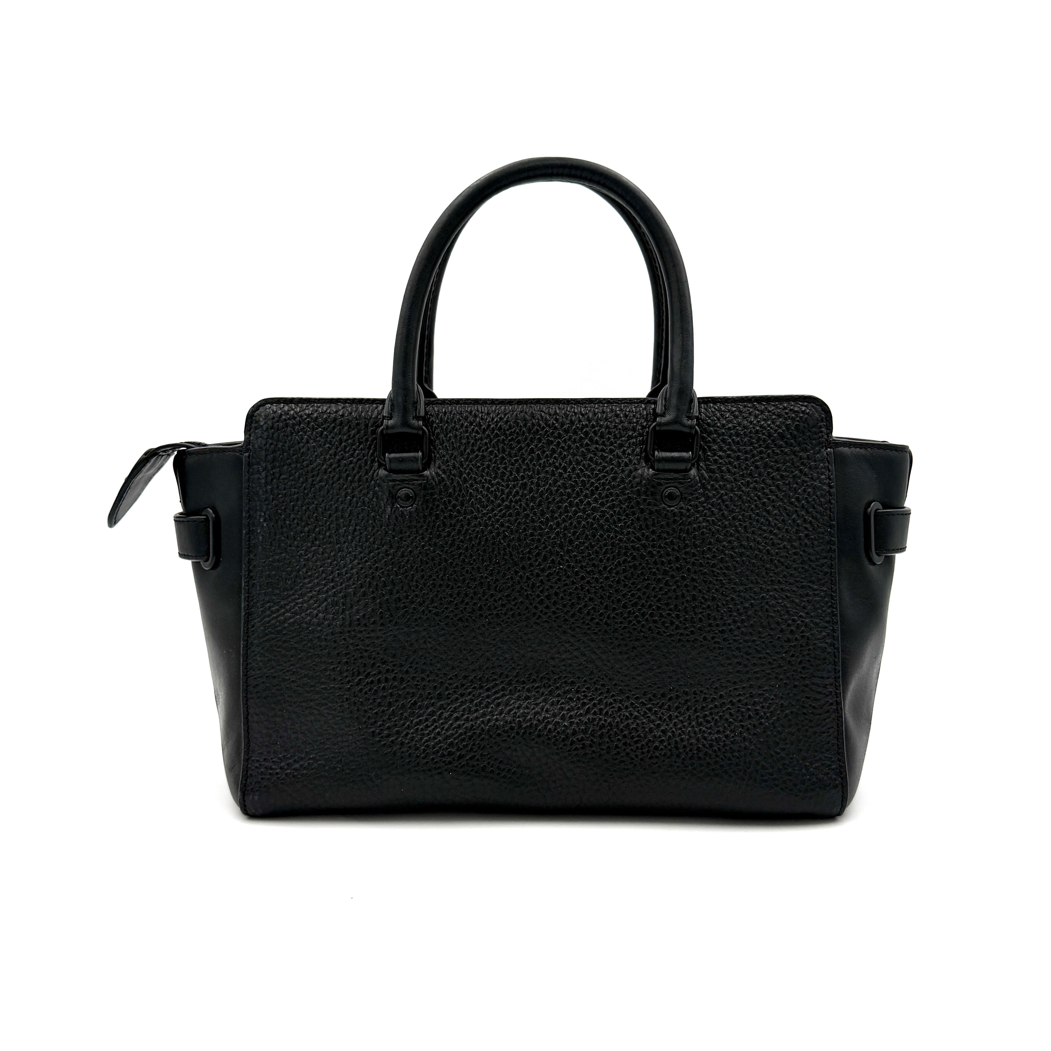 Coach Blake Carryall 25 bag in black pebbled leather with dual top handles, detachable strap, and front turnlock accents.