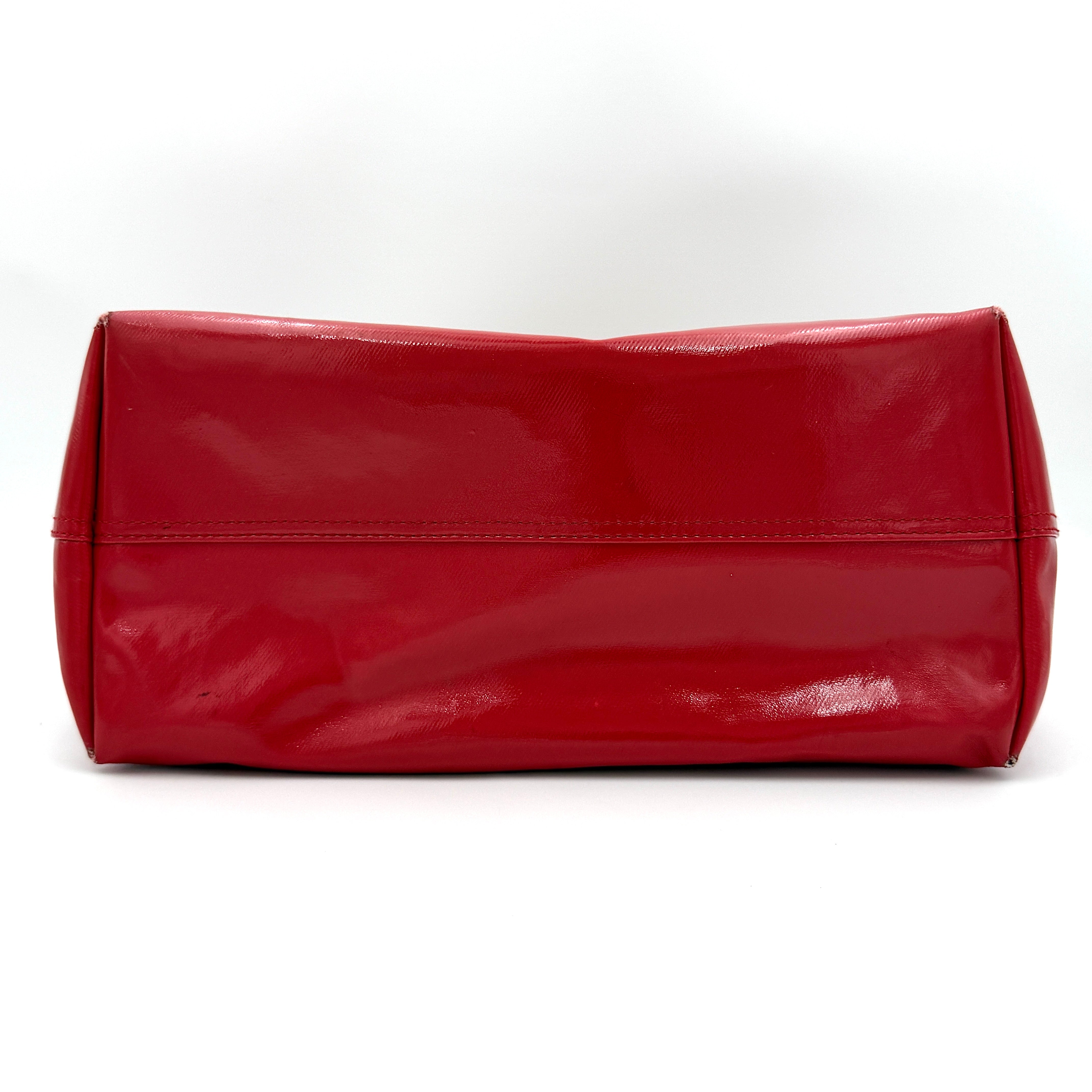 Kate Spade Ash Street Logo Tote in red canvas with glossy red leather base and ivory handles, shown against a white background.