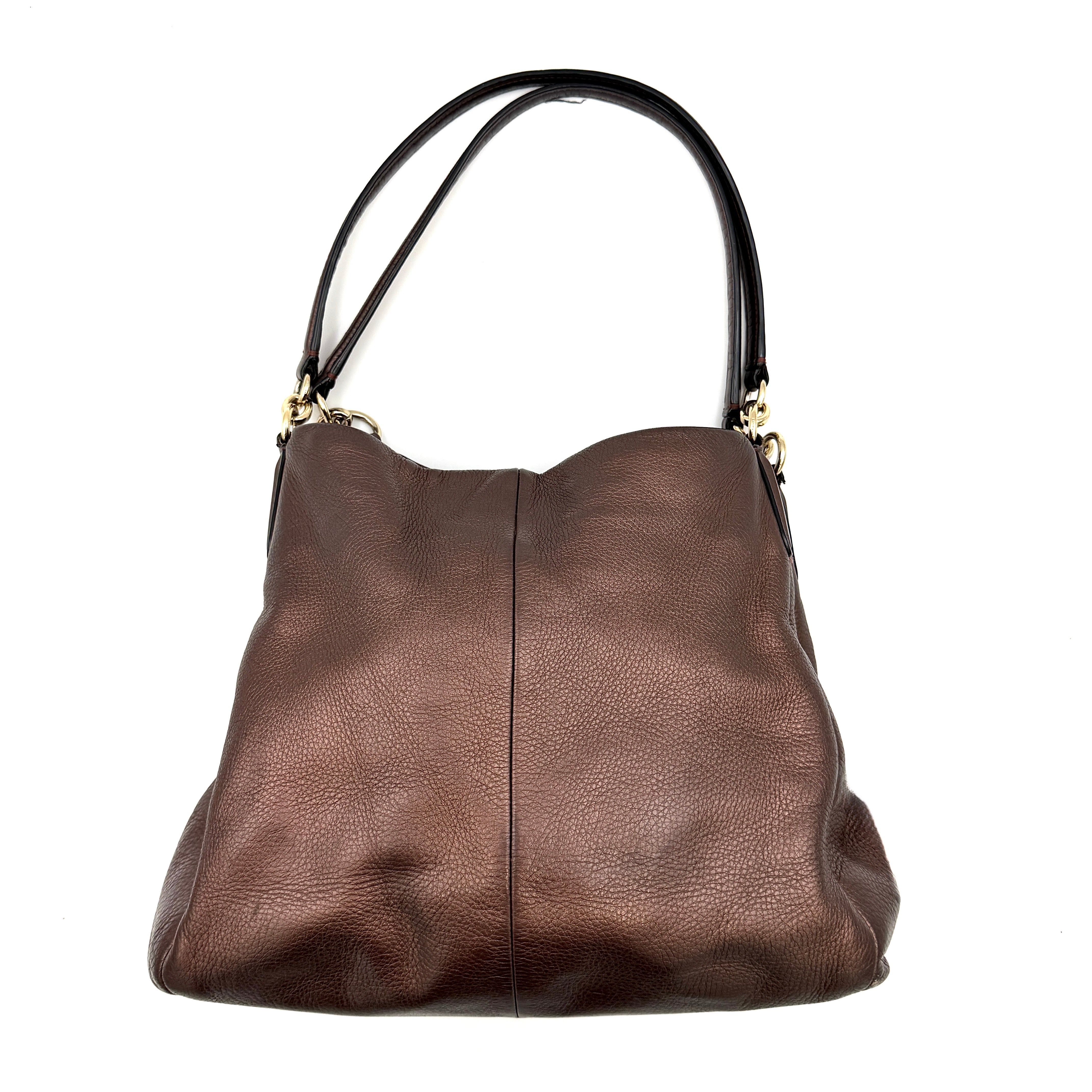 Coach Madison Phoebe Shoulder Bag in rich brown pebbled leather with double shoulder straps and gold-tone hardware, shown upright against a white backdrop.