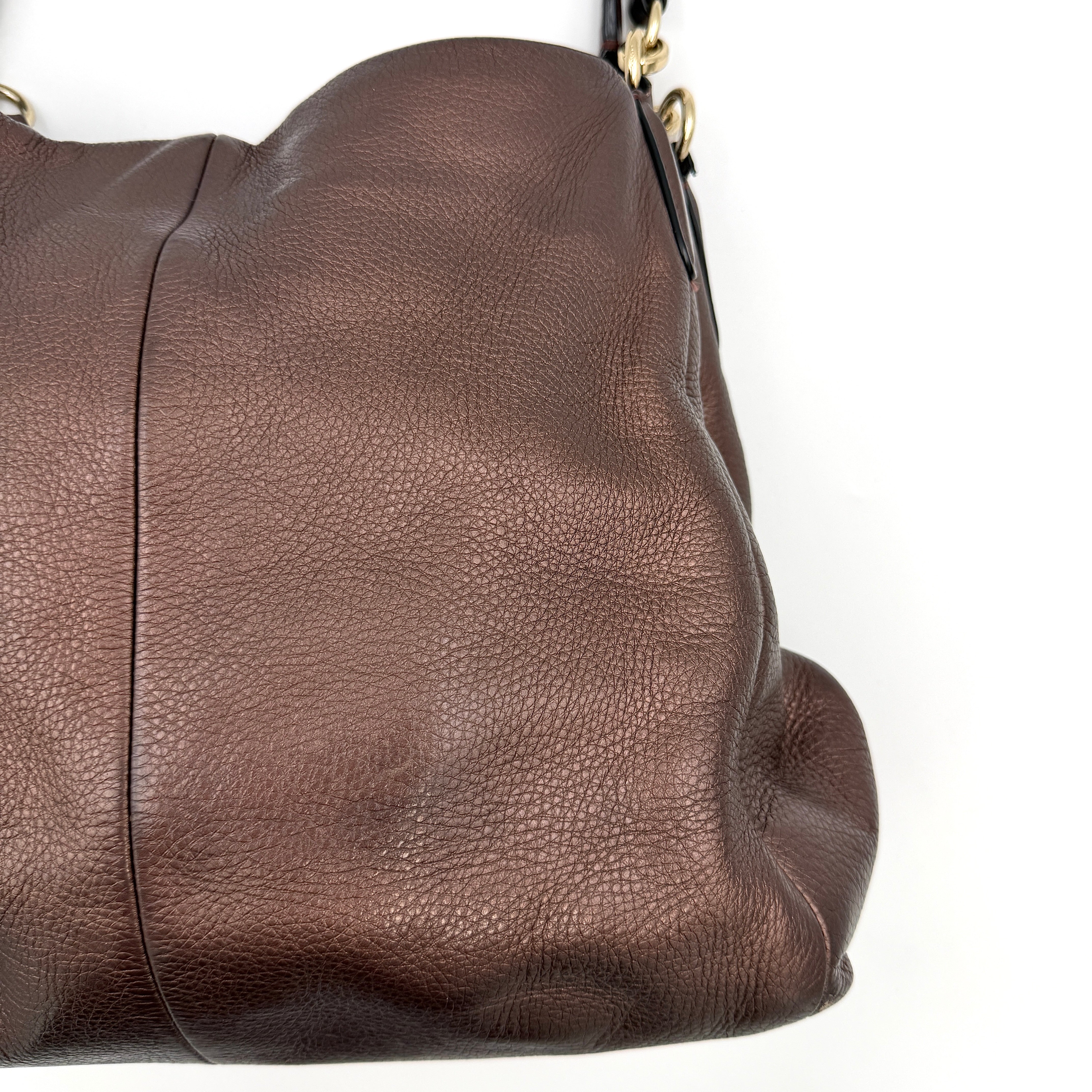 Coach Madison Phoebe Shoulder Bag in rich brown pebbled leather with double shoulder straps and gold-tone hardware, shown upright against a white backdrop.