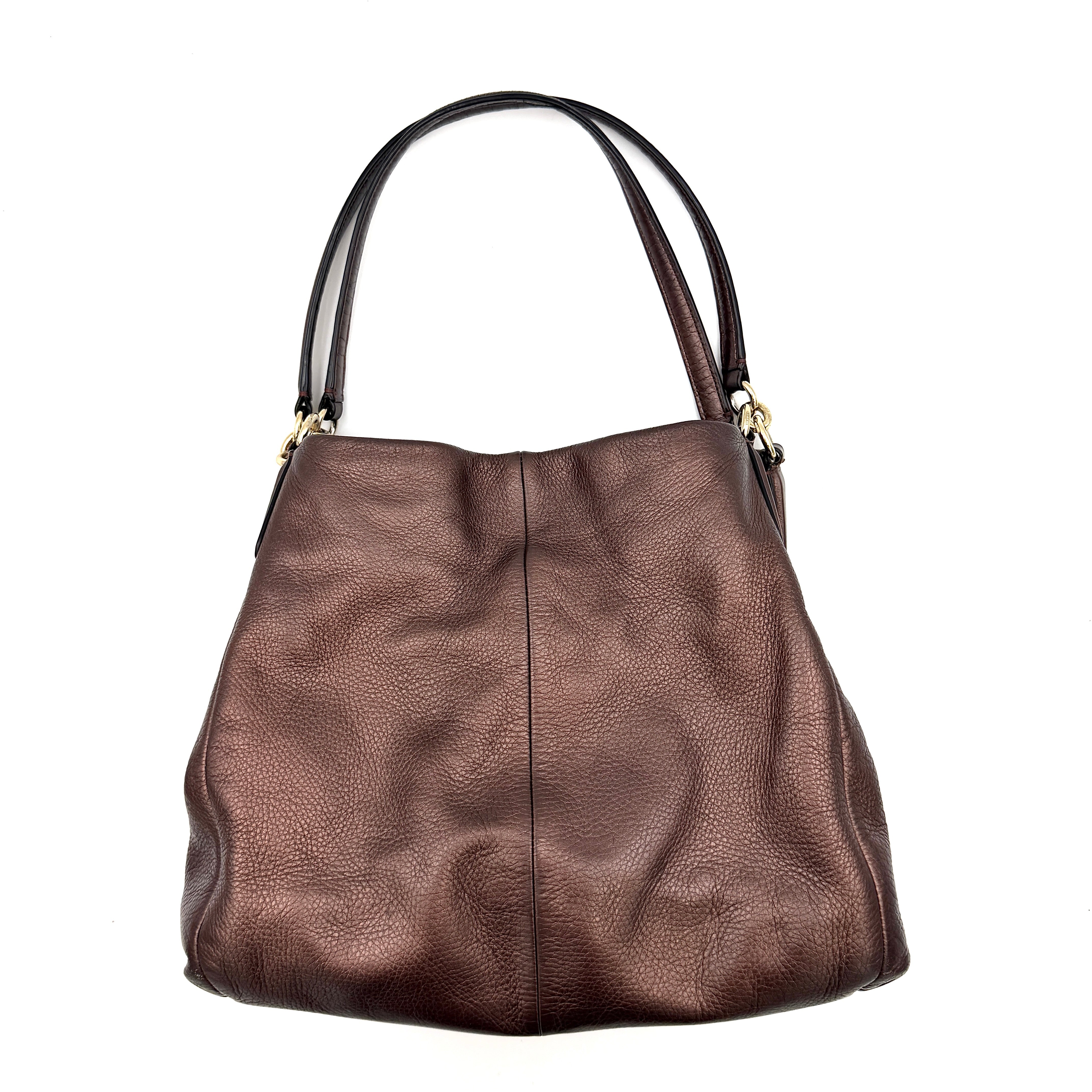 Coach Madison Phoebe Shoulder Bag in rich brown pebbled leather with double shoulder straps and gold-tone hardware, shown upright against a white backdrop.